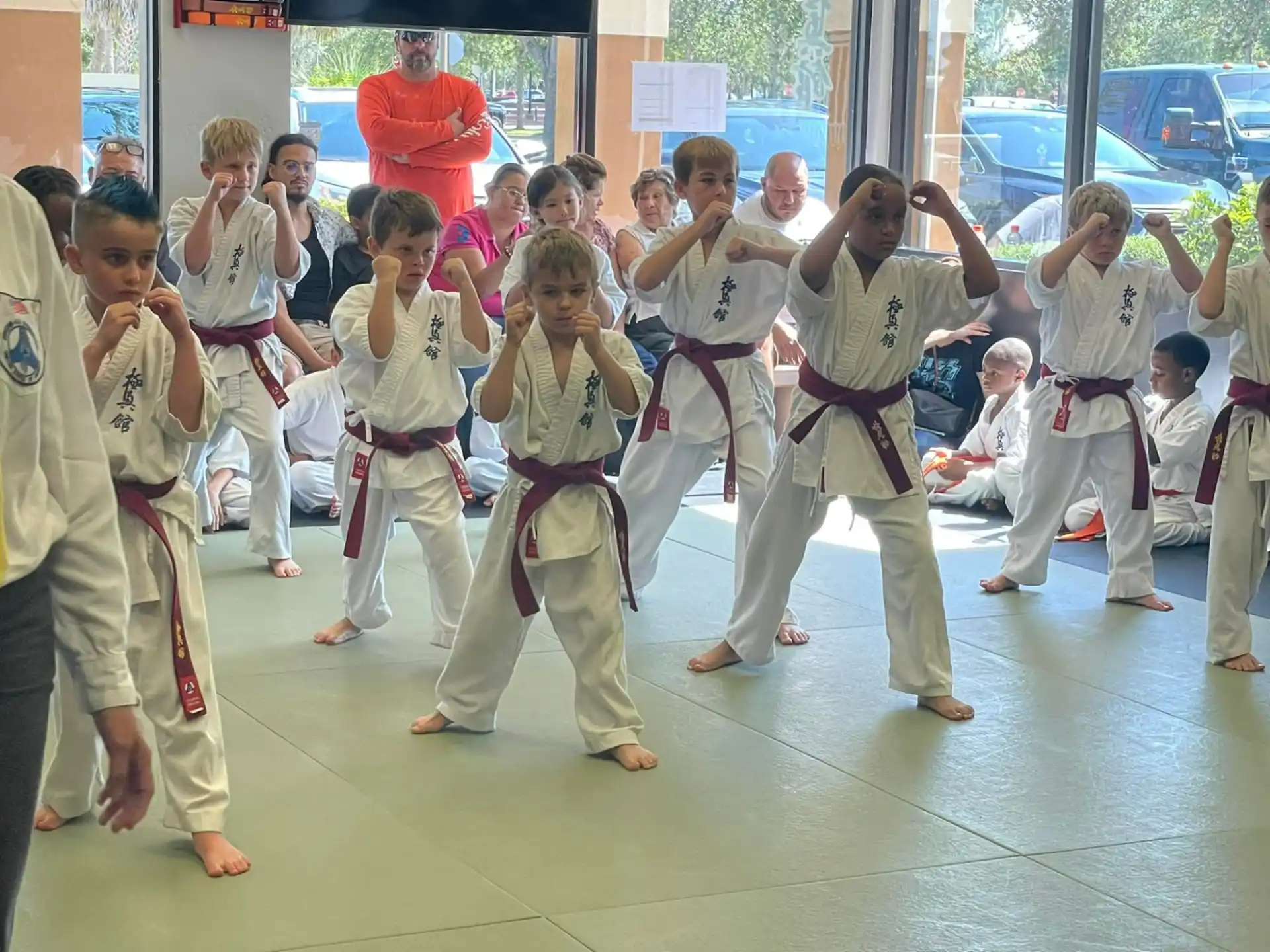 a group of children in karate uniforms
