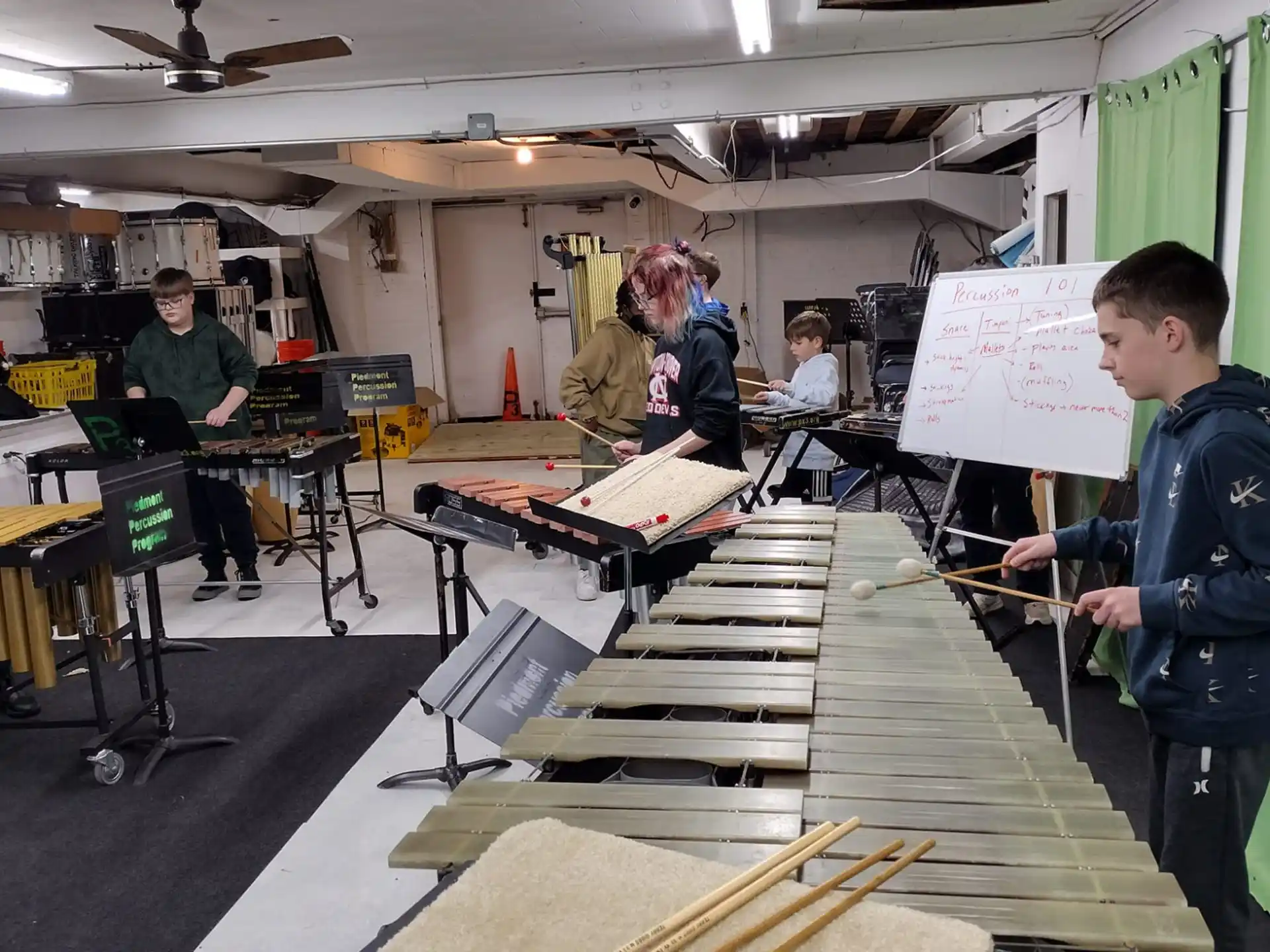 a group of people in a room with tables and a person playing a musical instrument