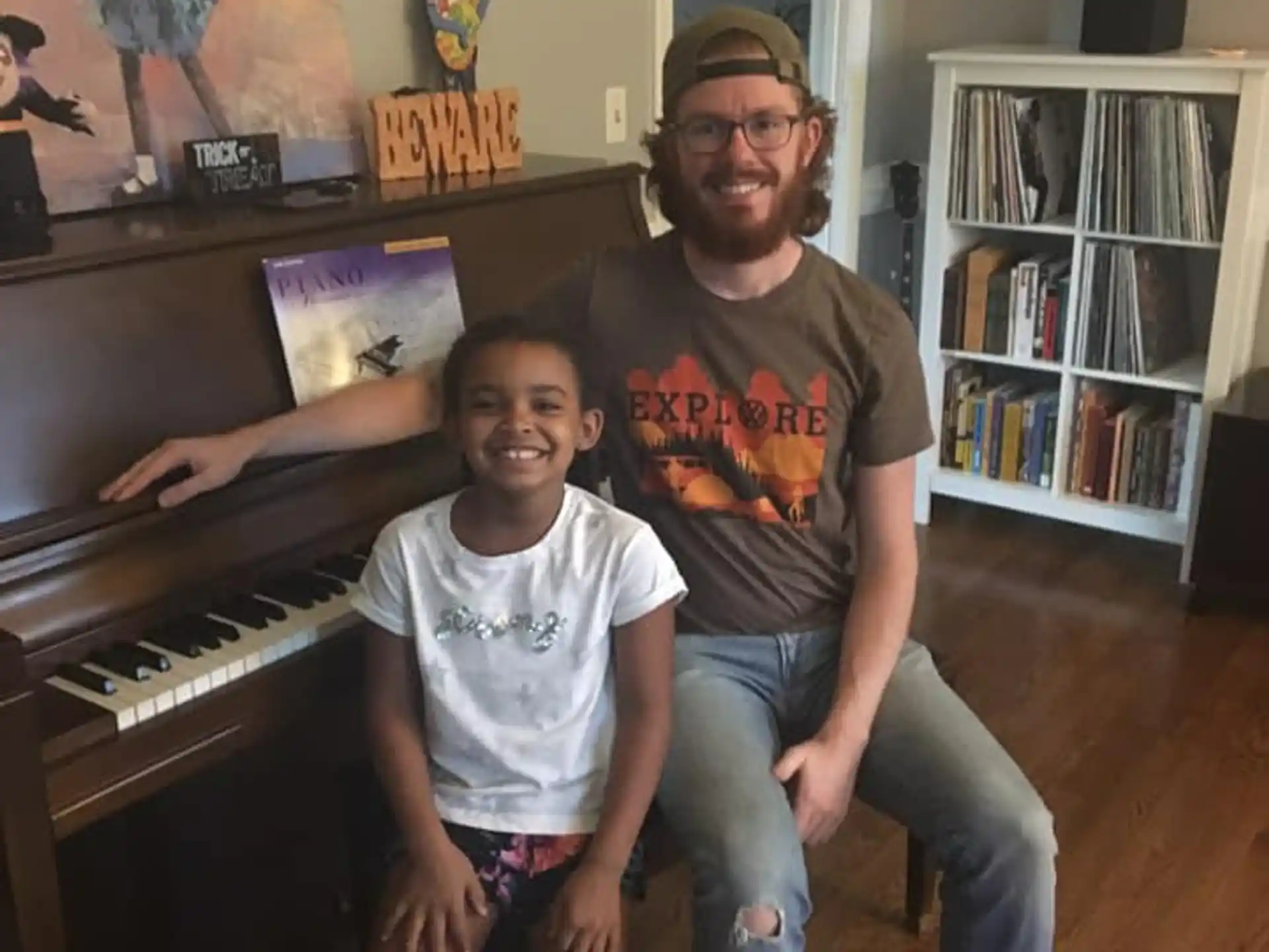a man and a boy sitting at a piano