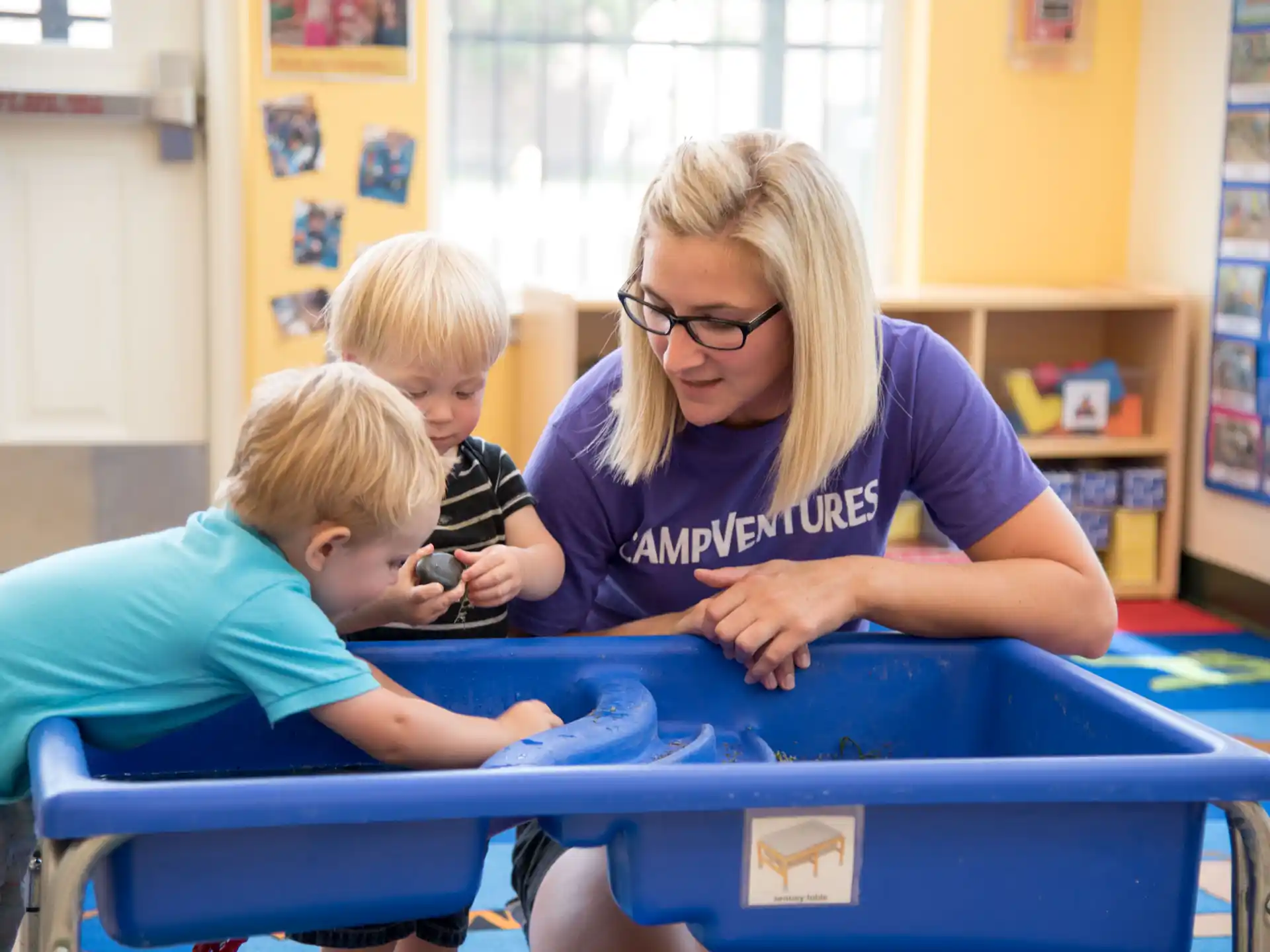 a woman and two children playing a game