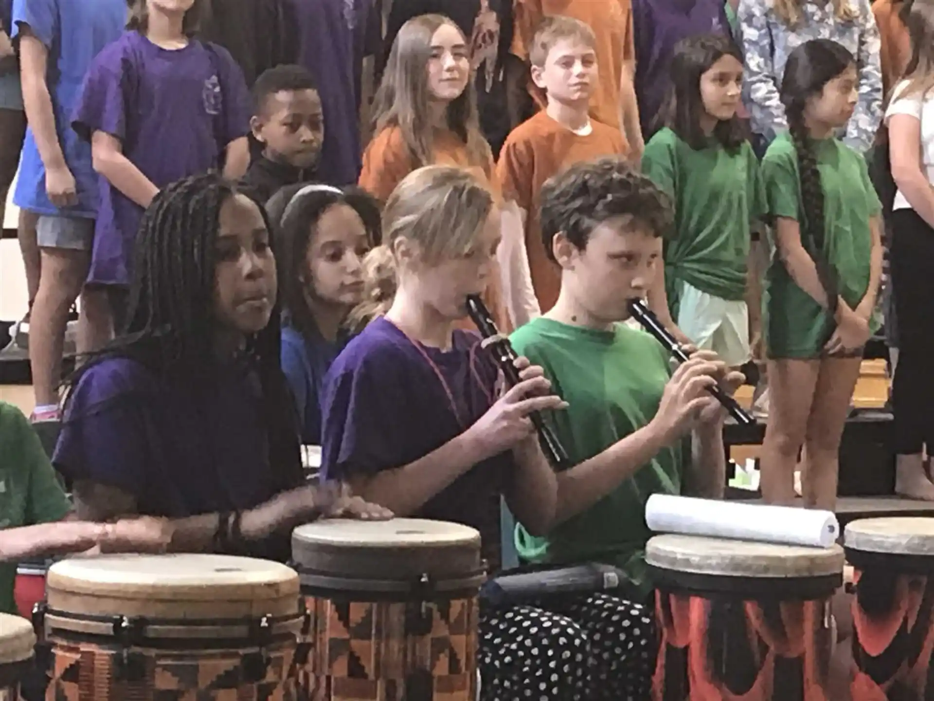 a group of kids playing drums