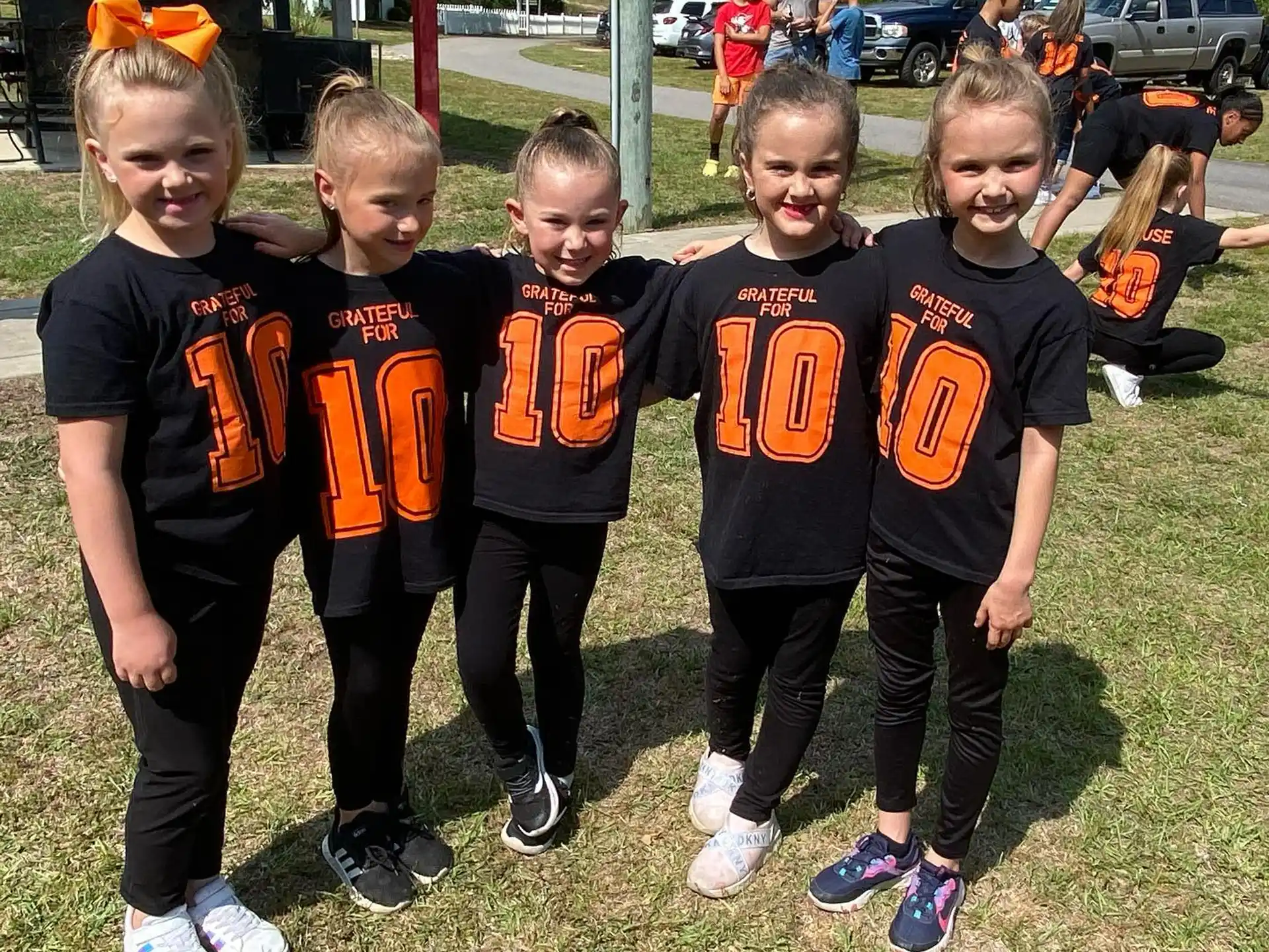 a group of children in matching black shirts