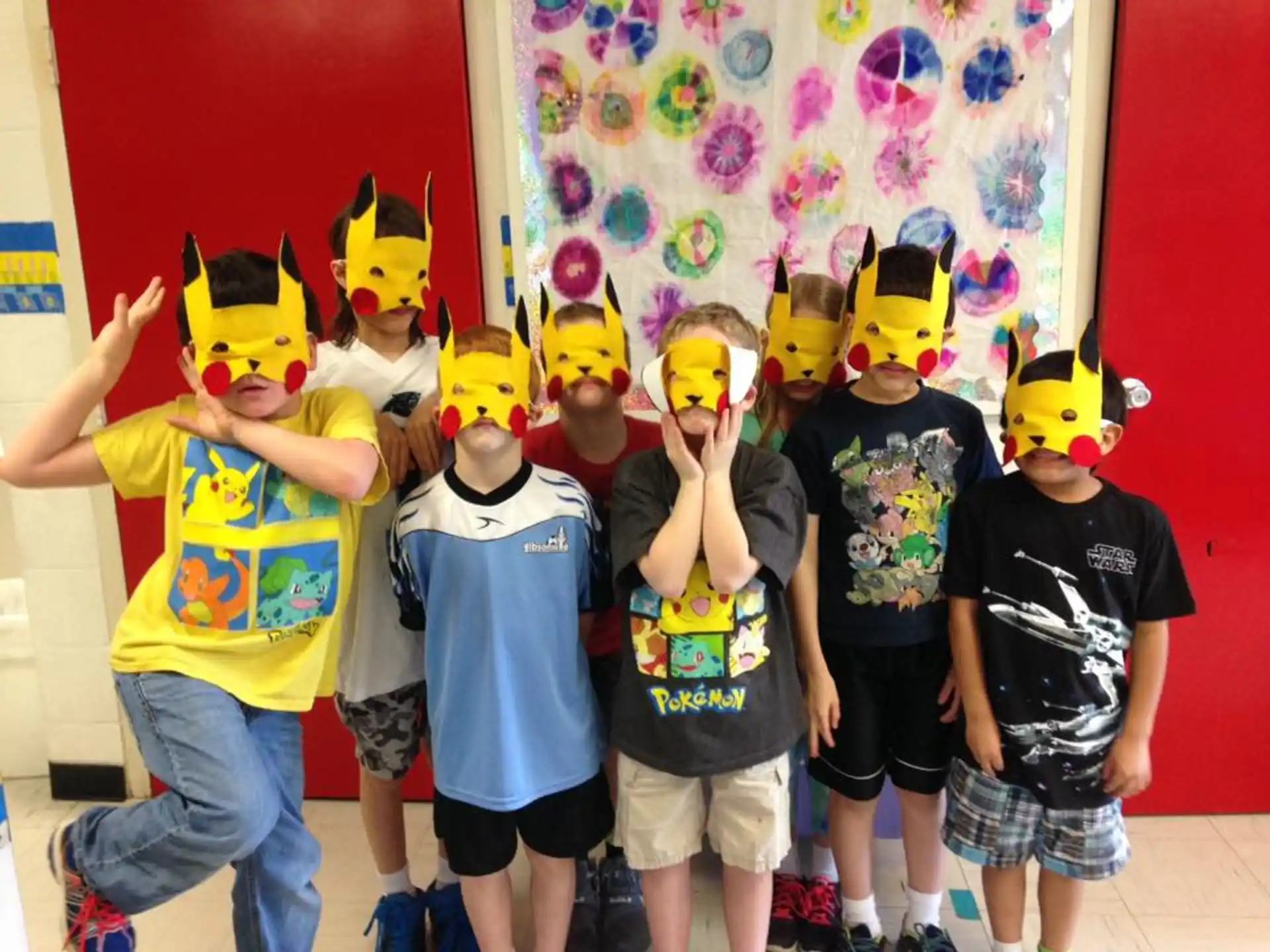 a group of kids wearing yellow hats