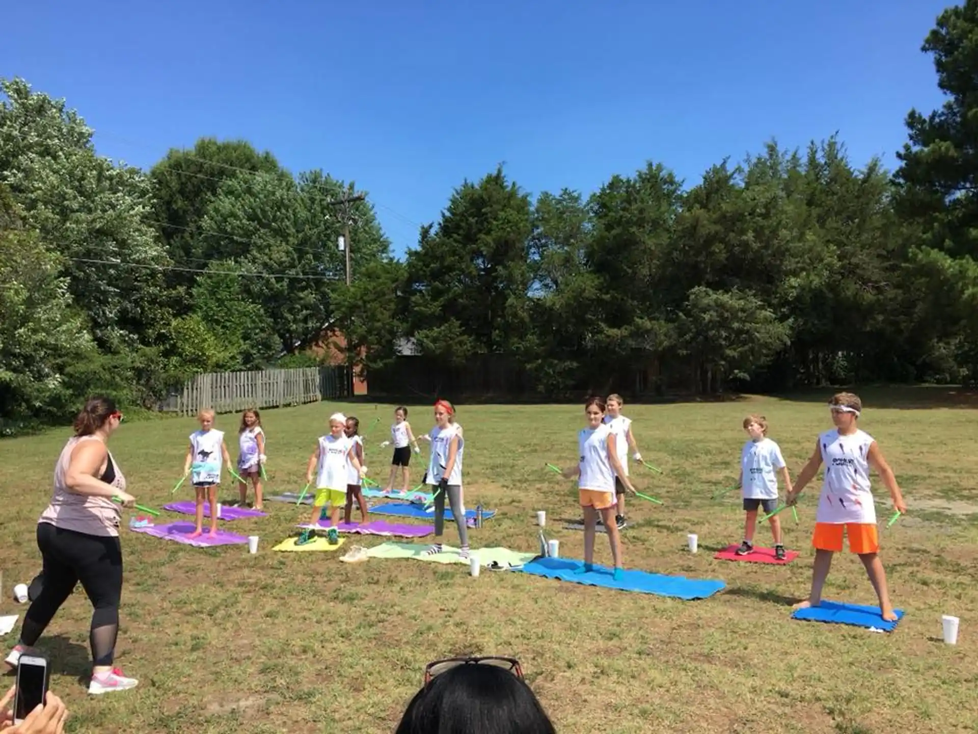 a group of people playing with kites in a field