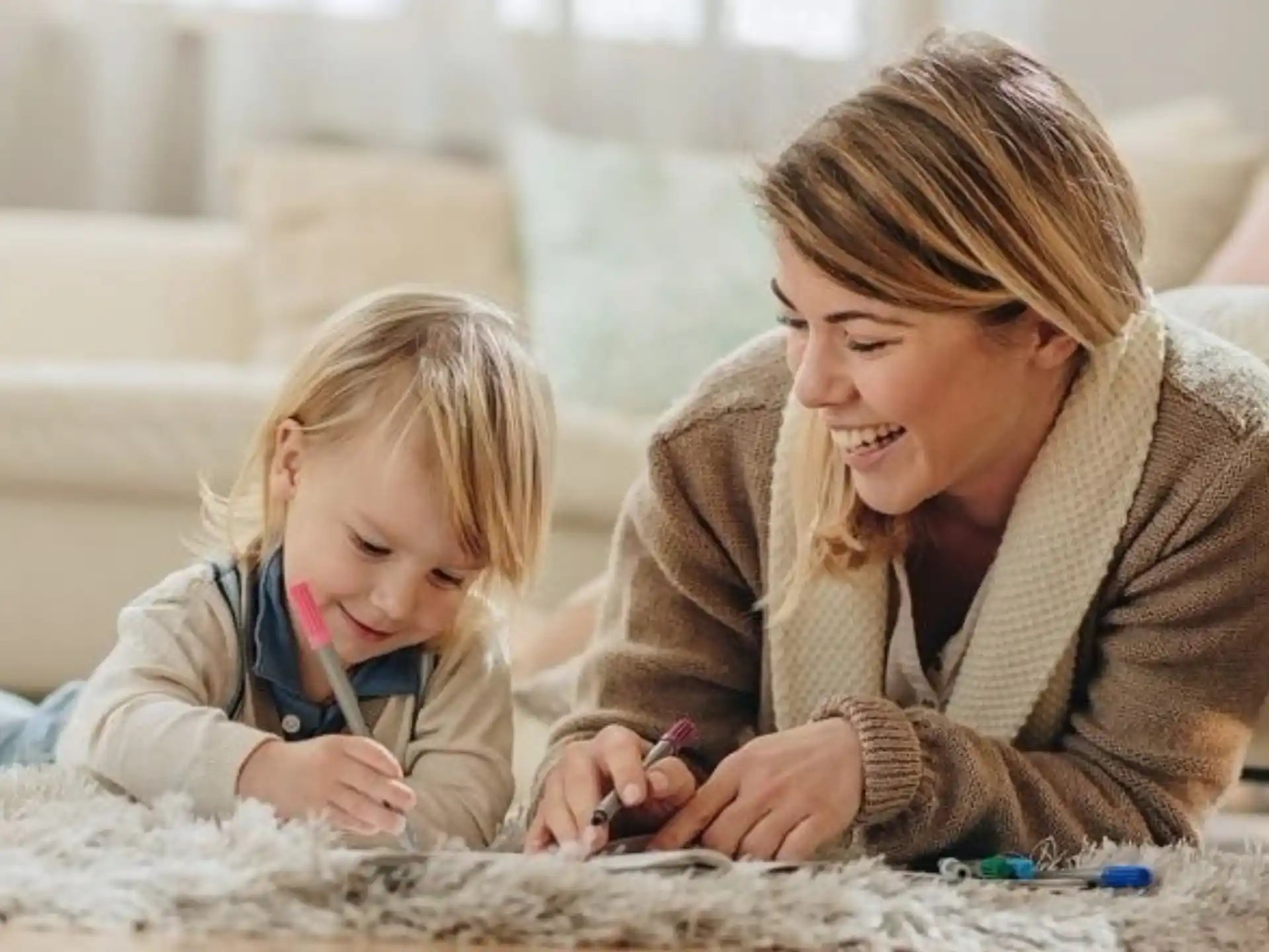 a woman and a child playing with a toy
