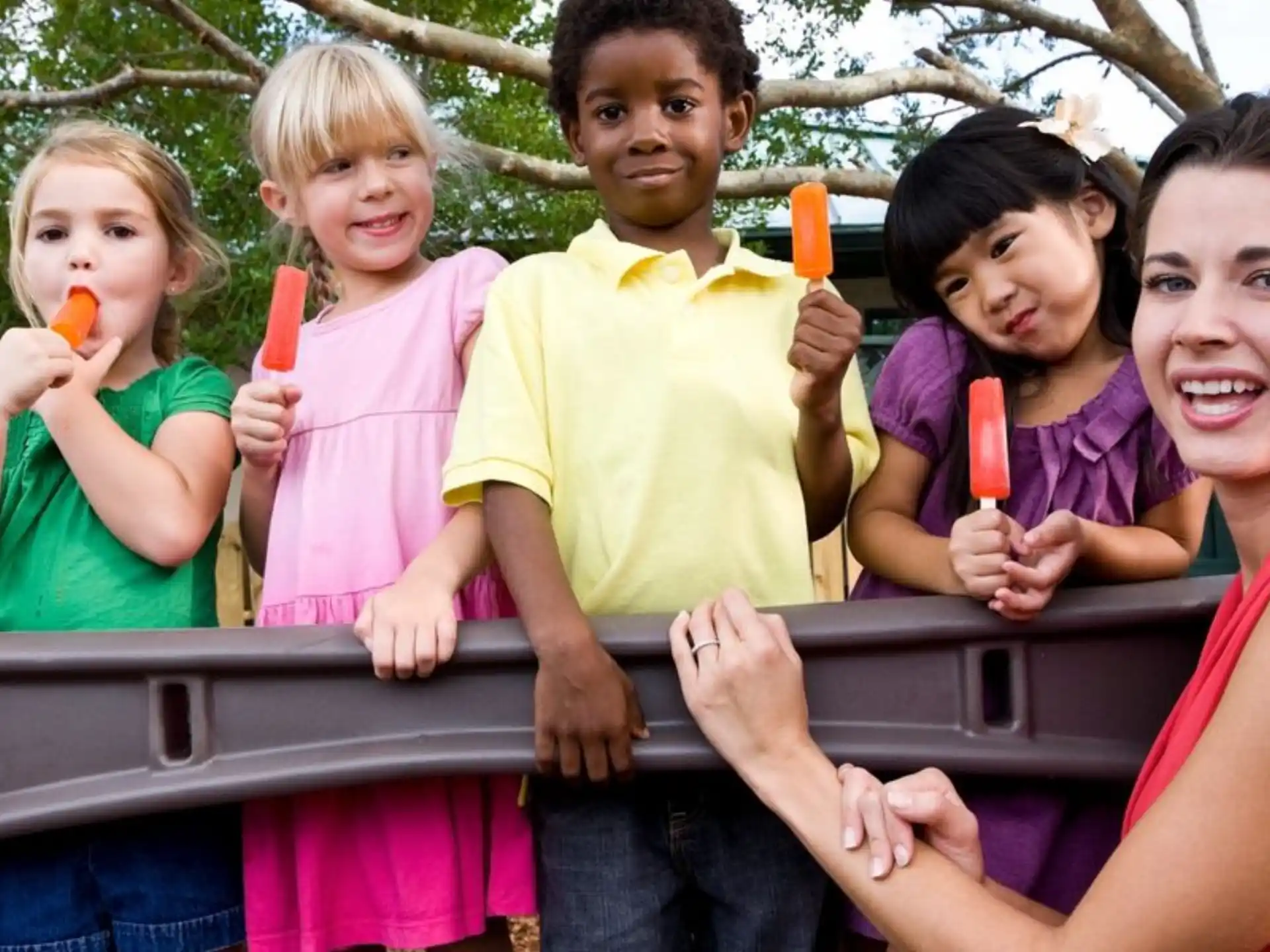 a group of children holding toothbrushes