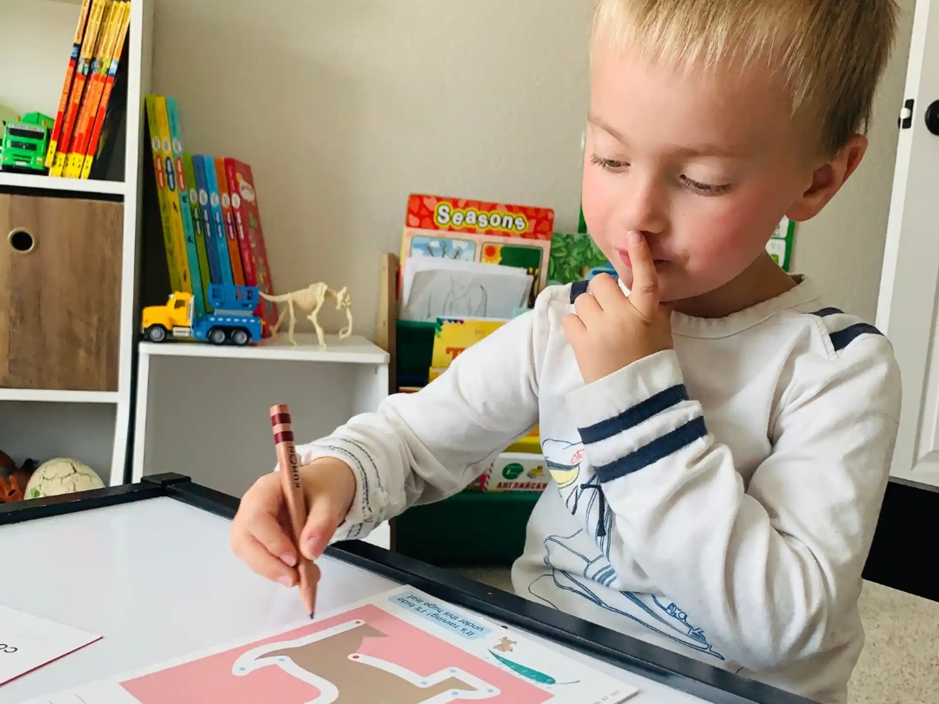 a child drawing on a paper