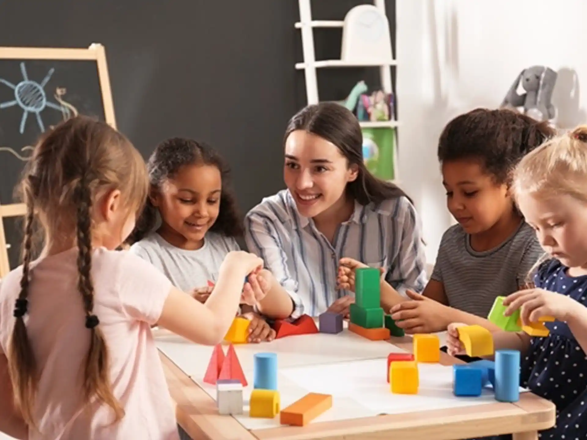 a group of children sitting around a table