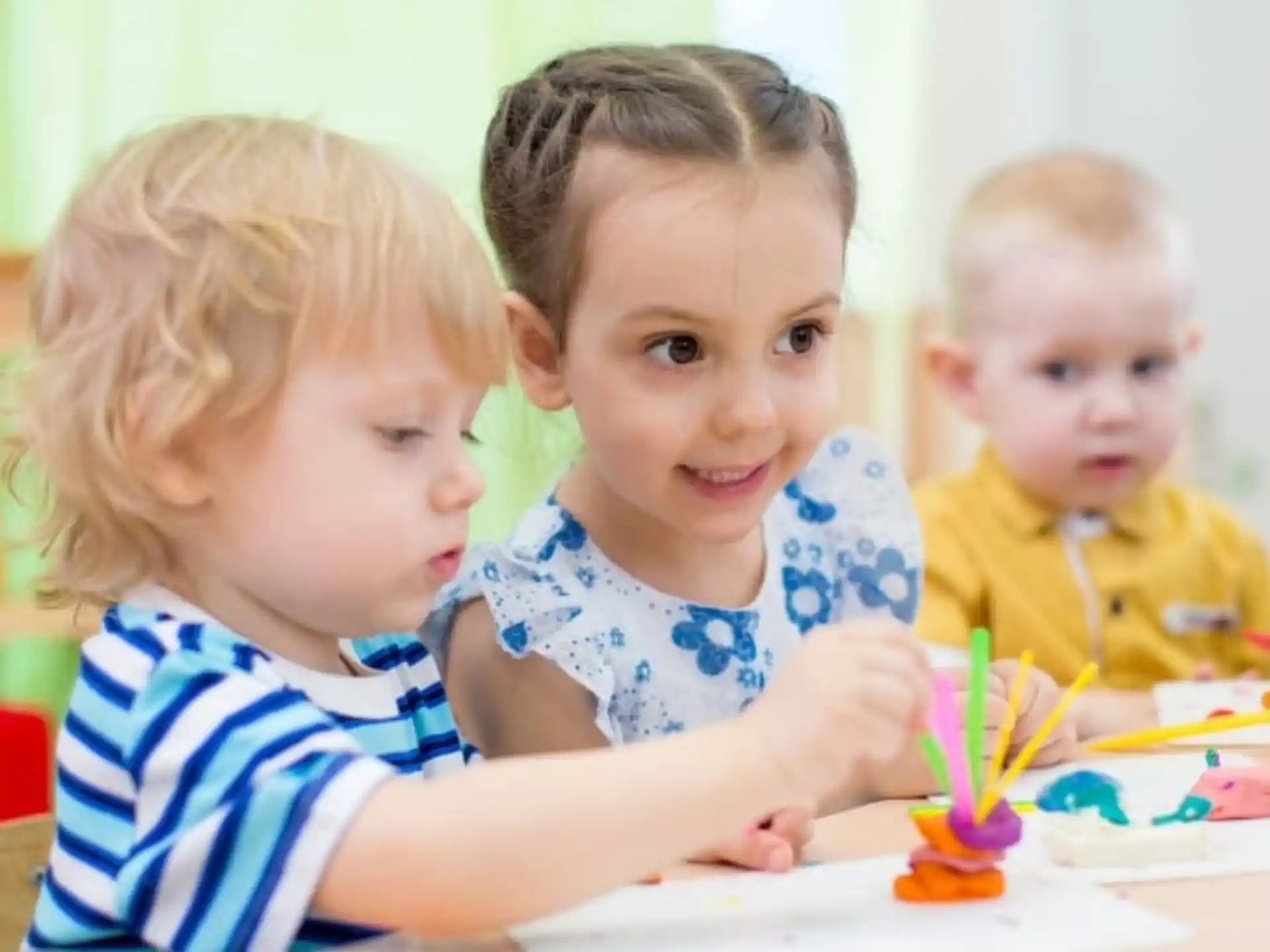 a group of children sitting at a table