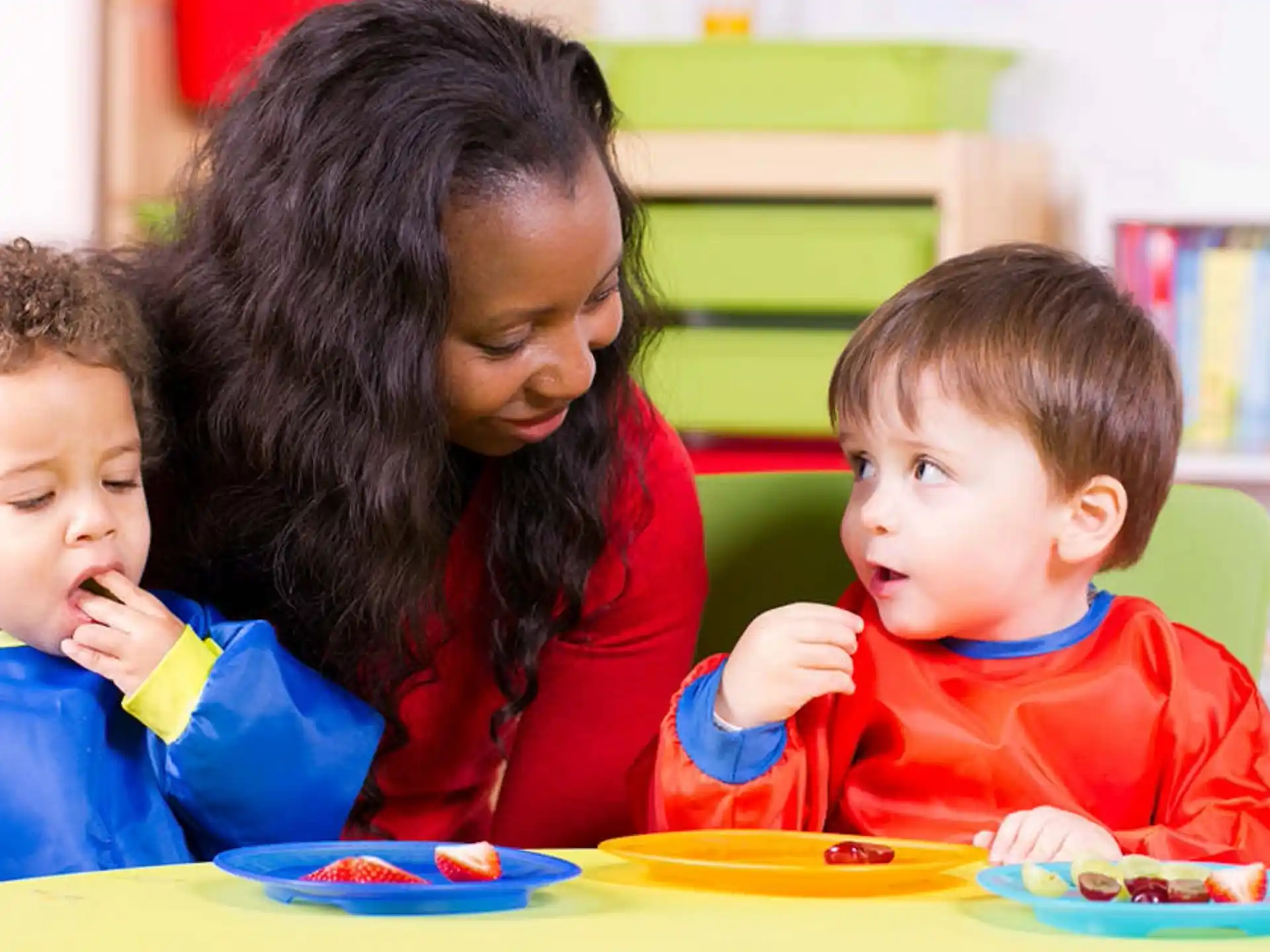 a person and two children eating
