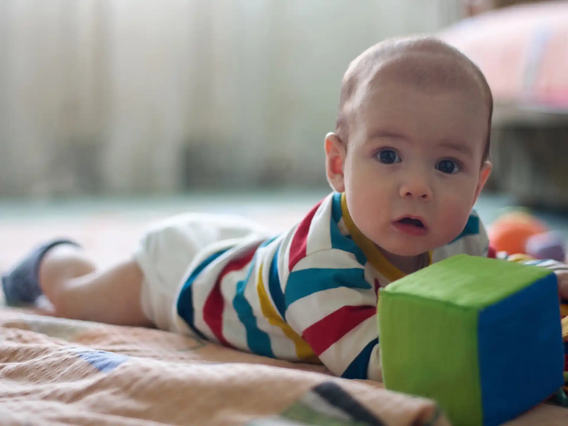 a baby lying on a blanket