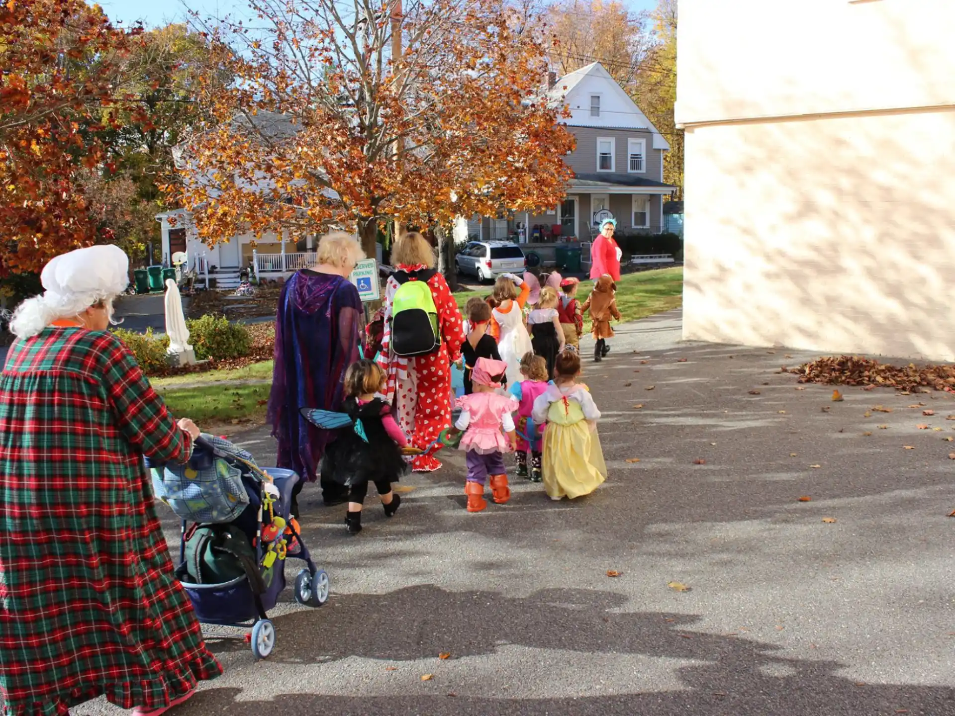 a group of people walking down a street with a dog and a person