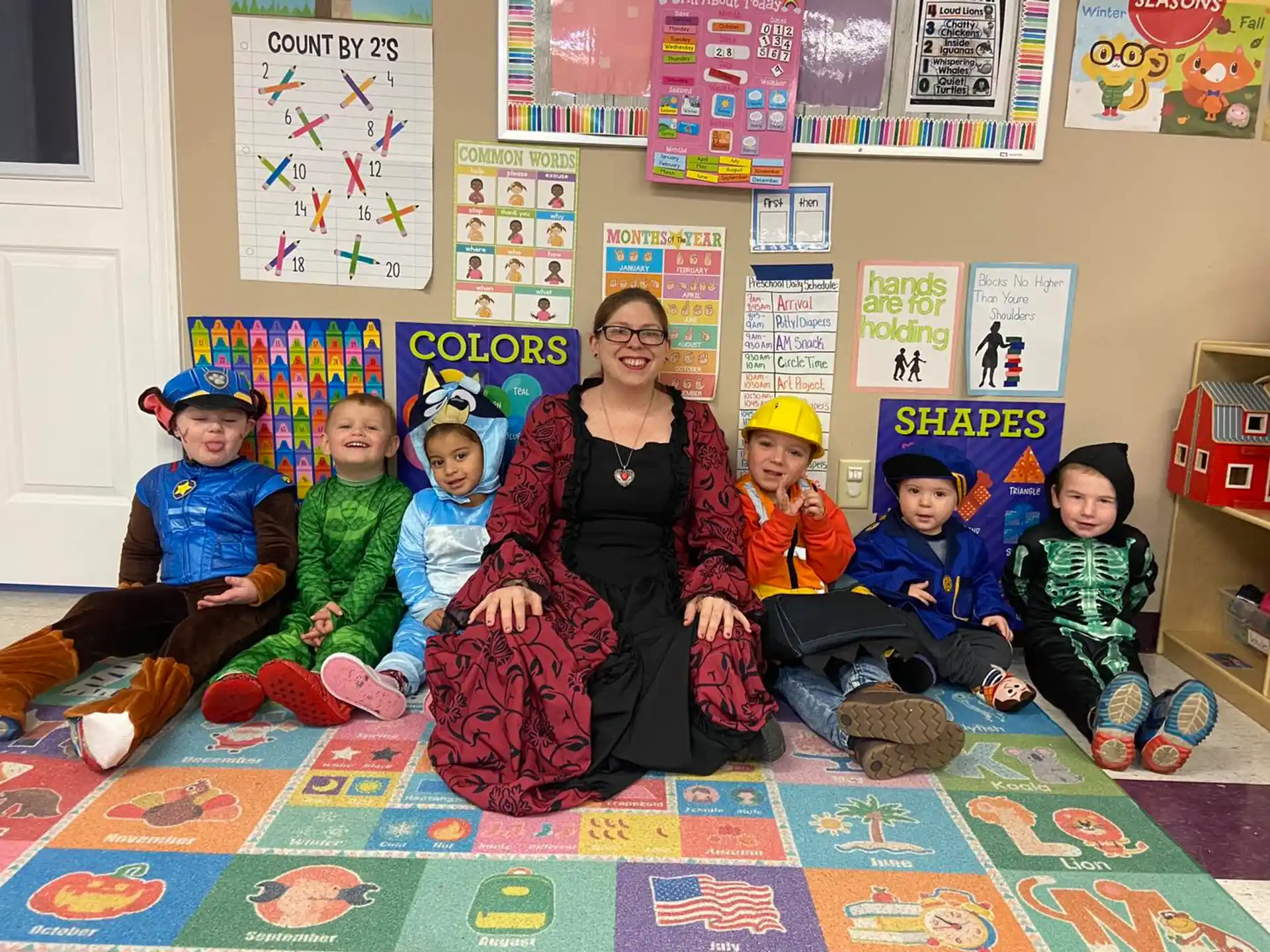 a person and several children sitting on the floor