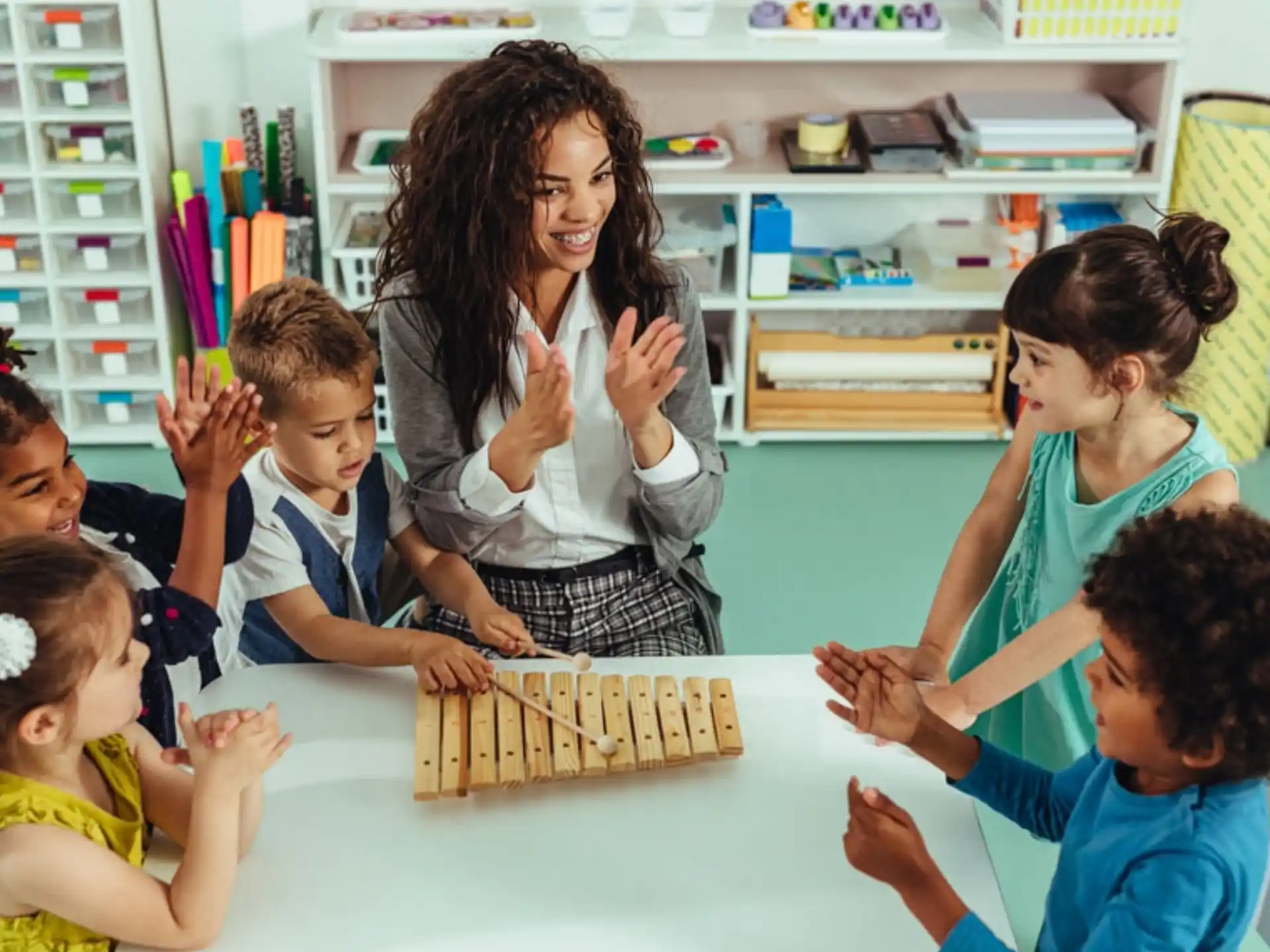 a person and several children playing chess