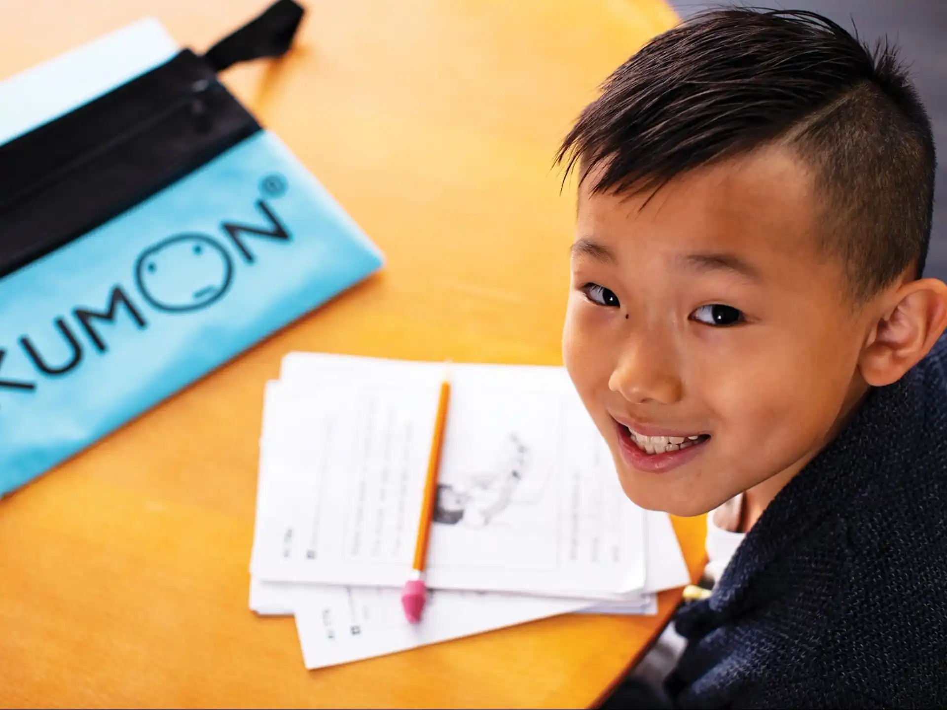 a boy sitting at a desk