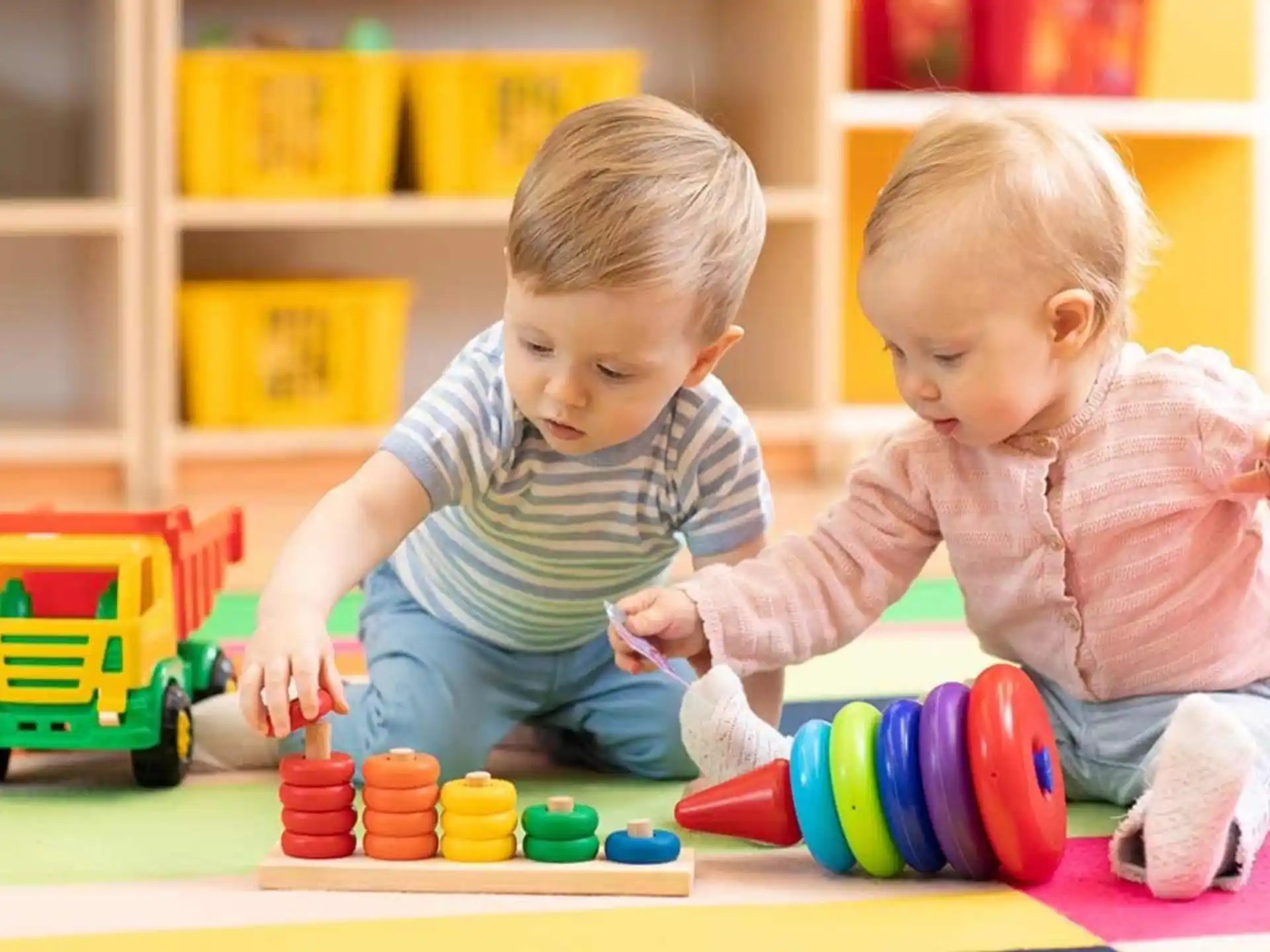 a couple of children playing with toys