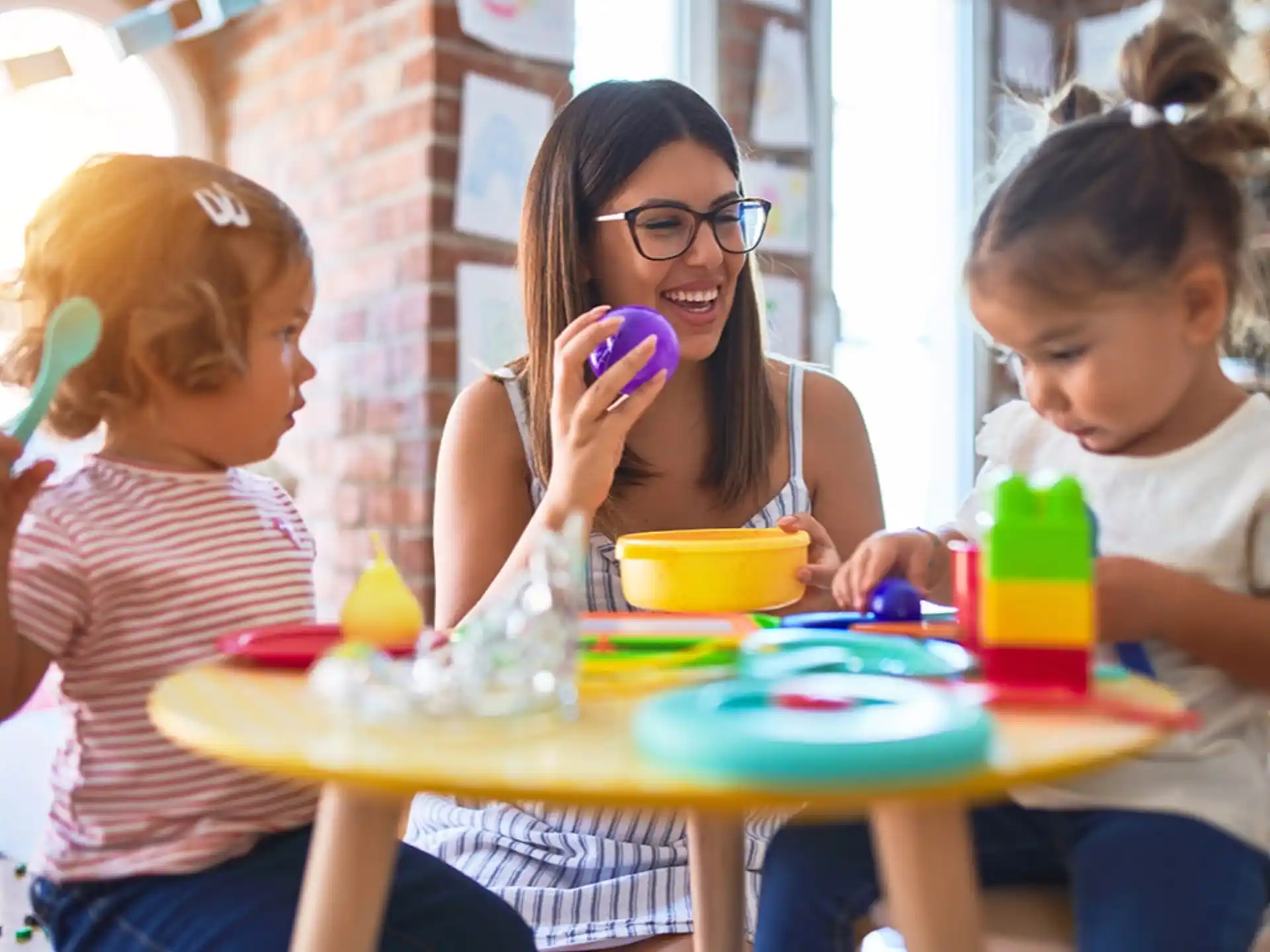 a person and kids eating at a table