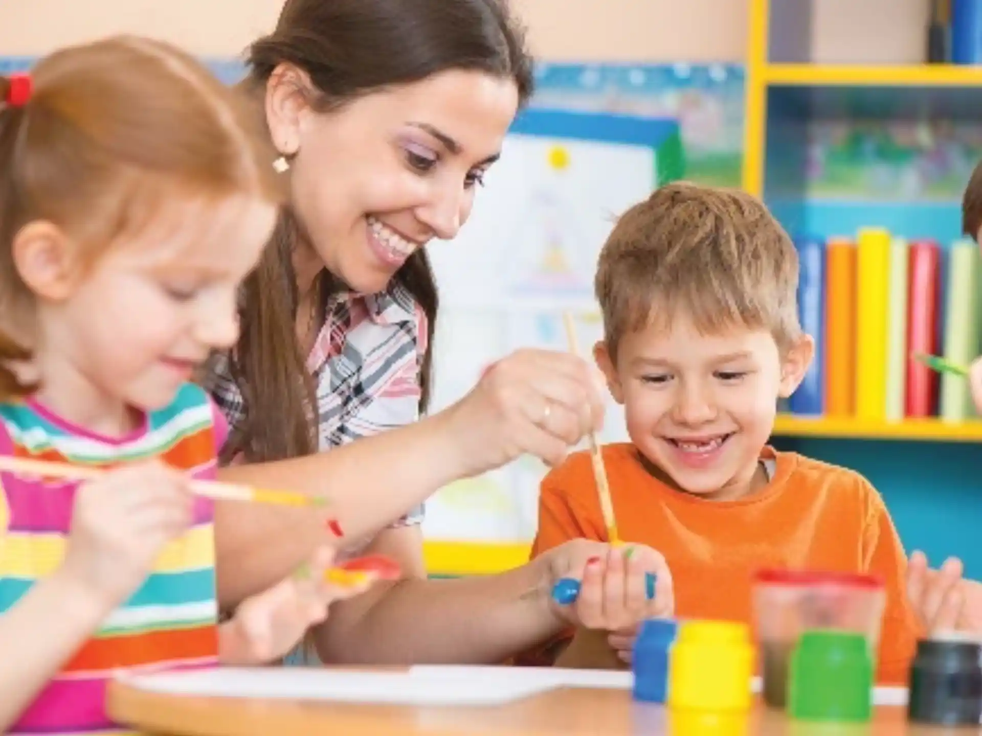 a person and children painting