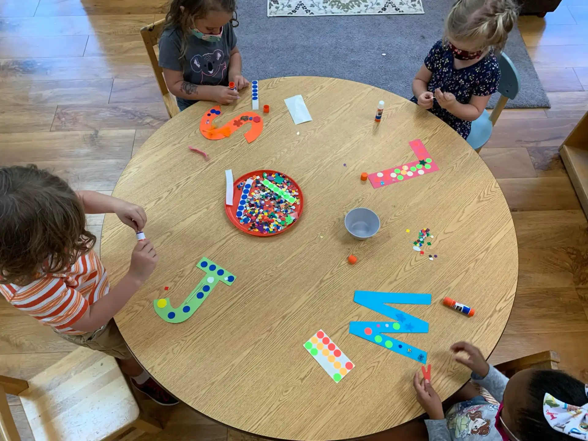 children playing with toys on a table