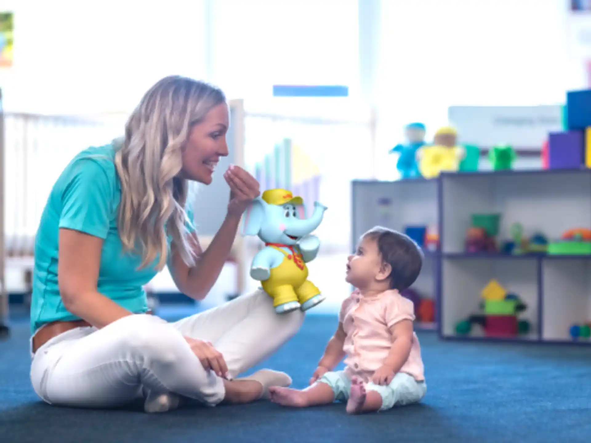 a woman and a child playing with a toy
