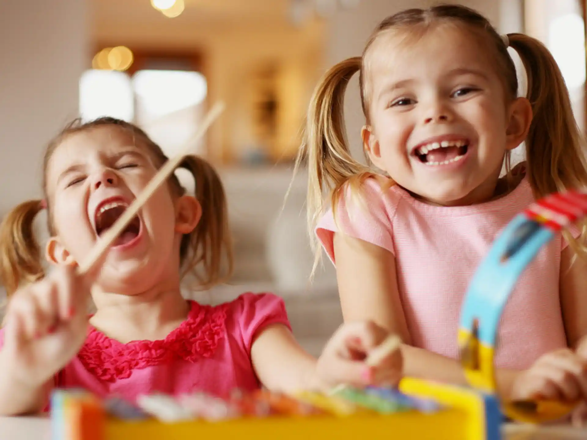a couple of young girls playing with toys