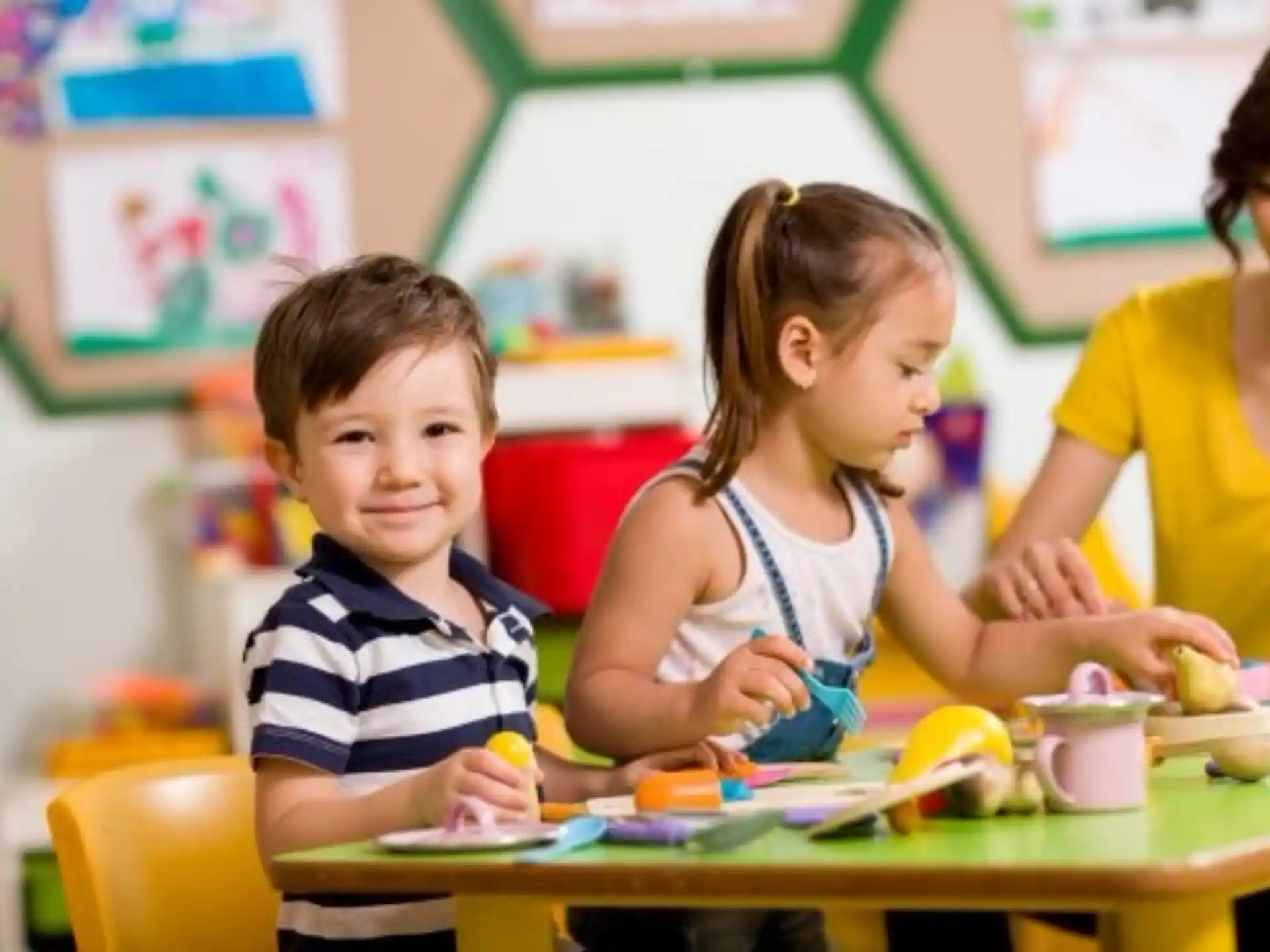 a few children sitting at a table