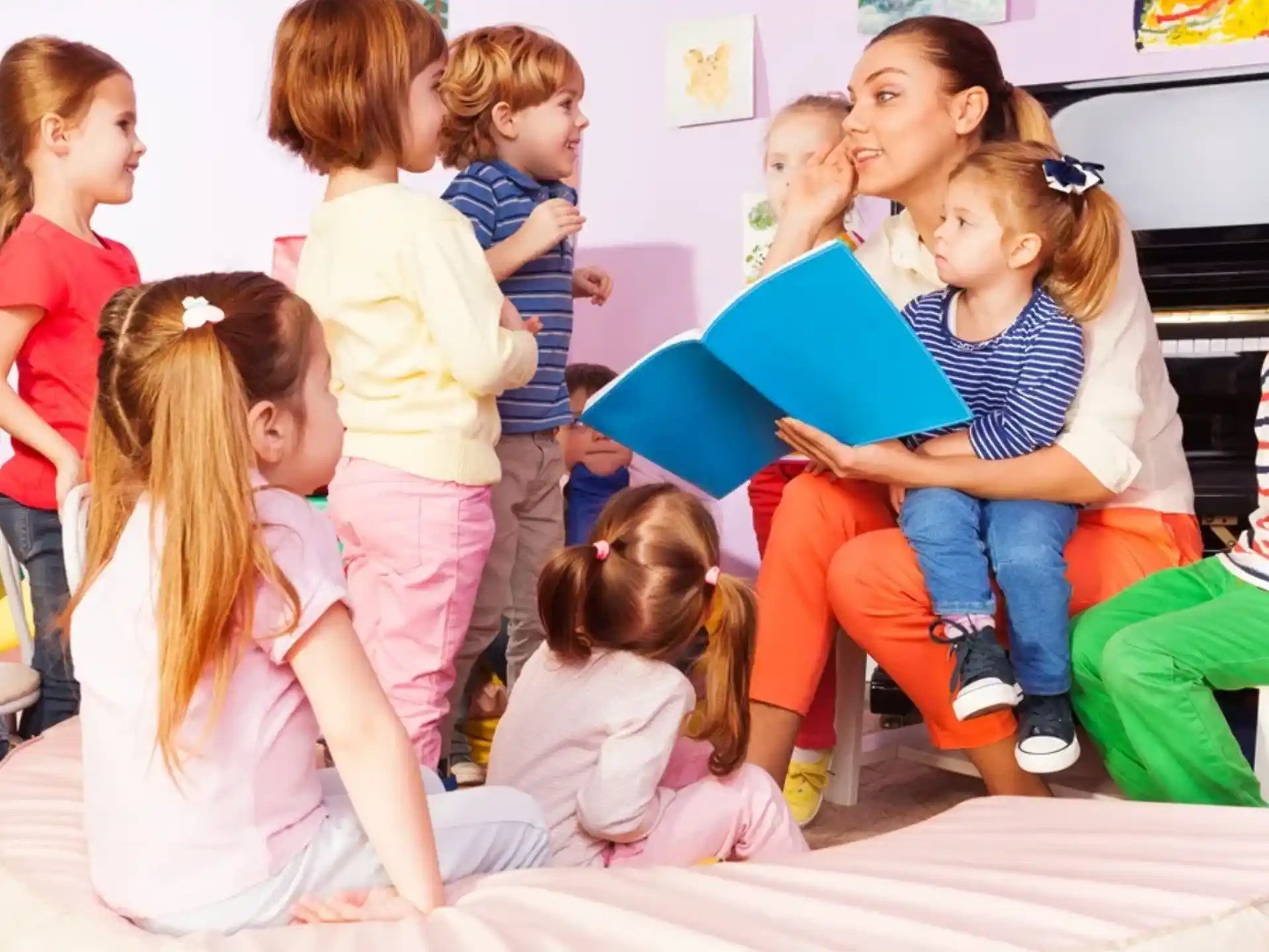 a group of children sitting on a bed