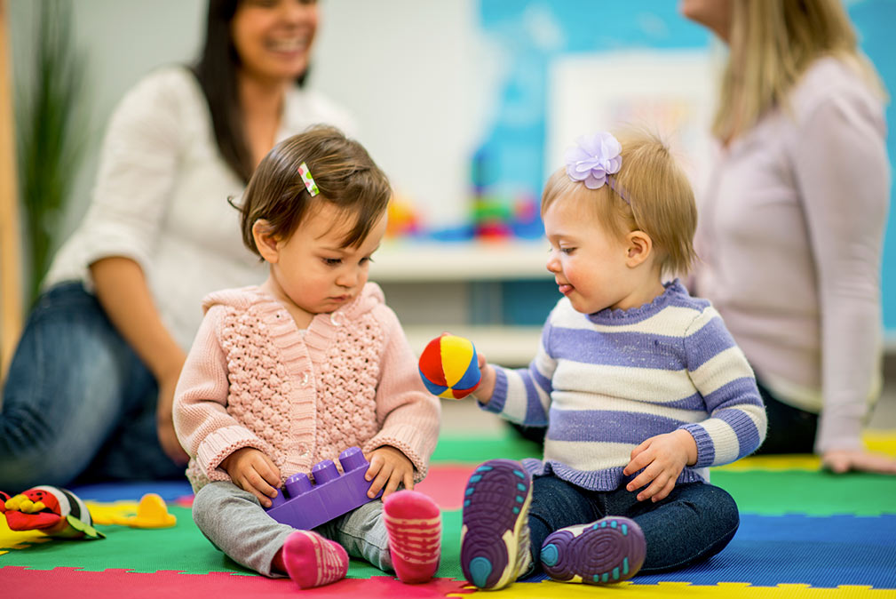 a couple of children sitting on the floor
