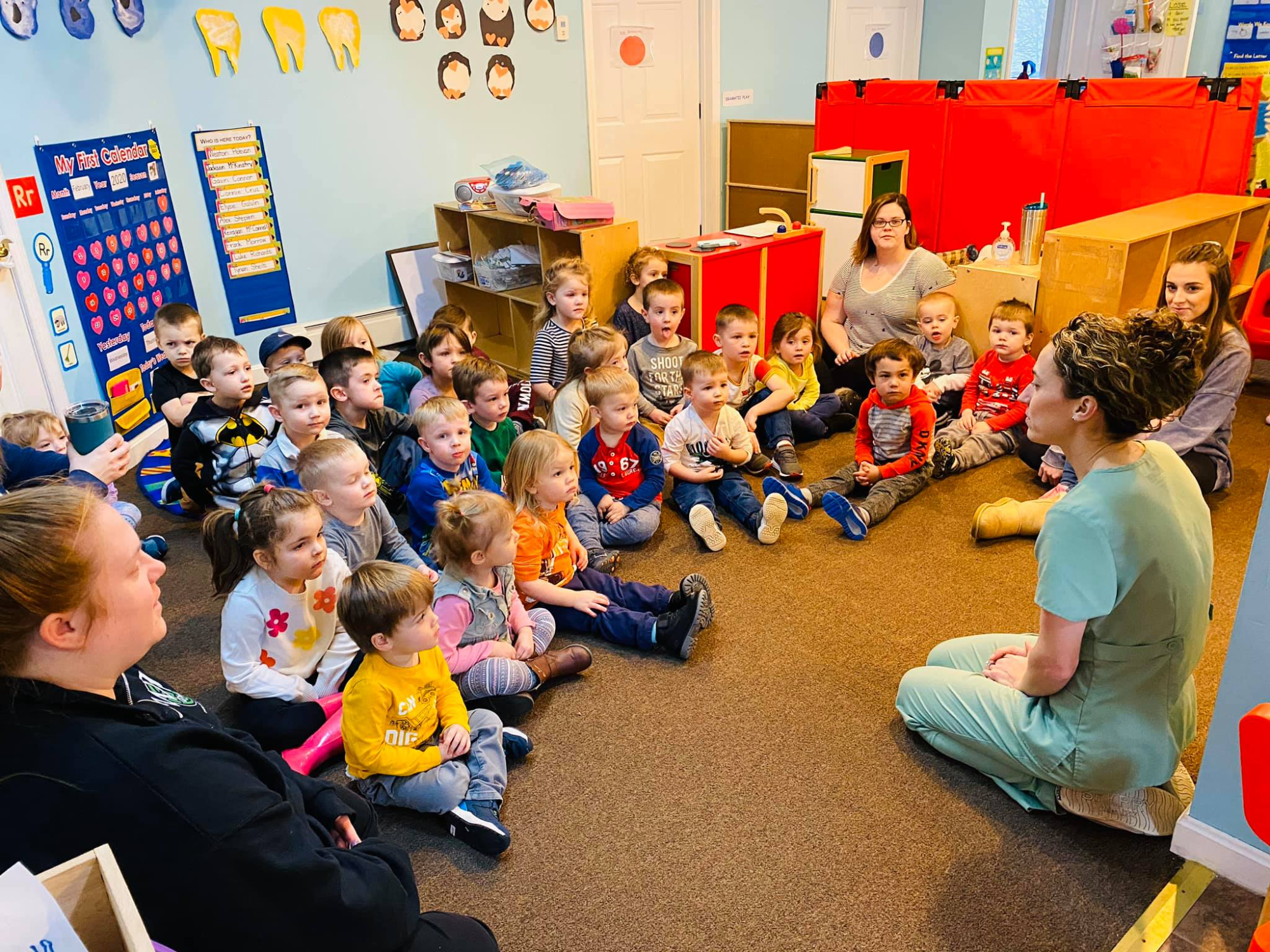 a group of children sitting in a classroom