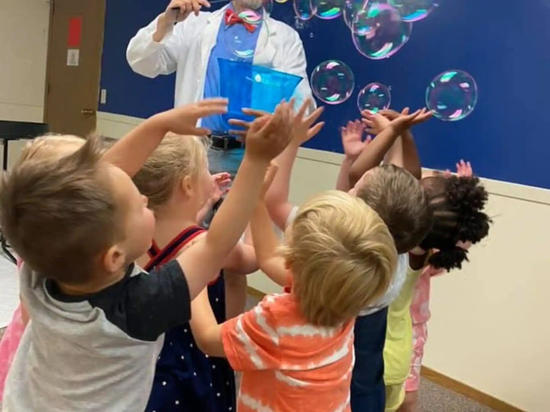a group of children playing with bubbles