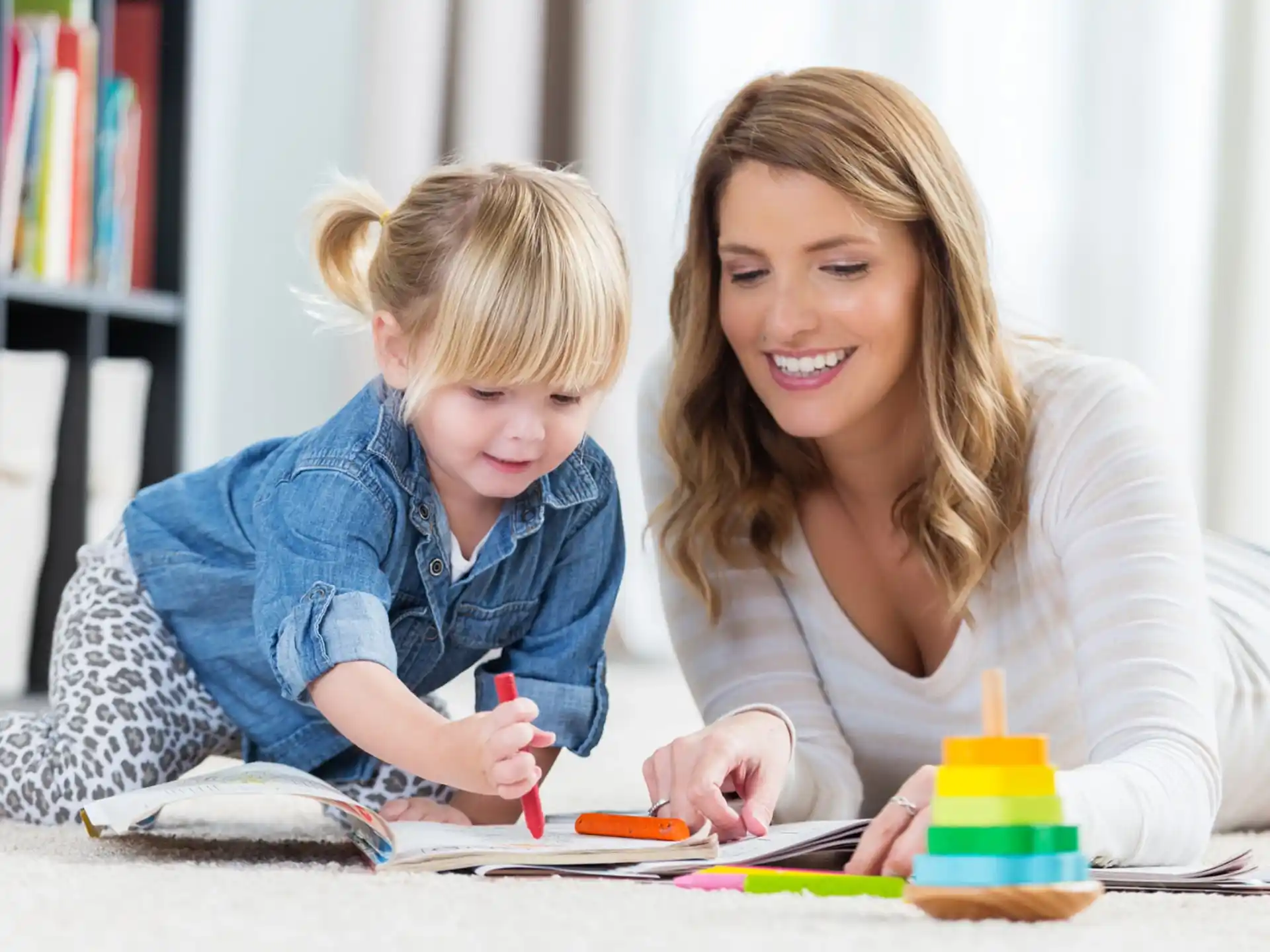 a person and a child playing with a toy