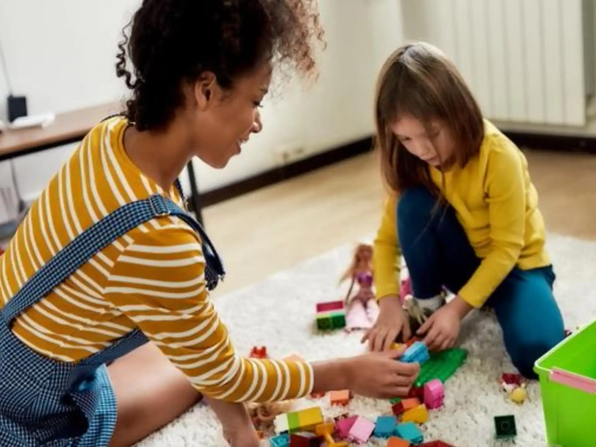a person and a child playing with toys