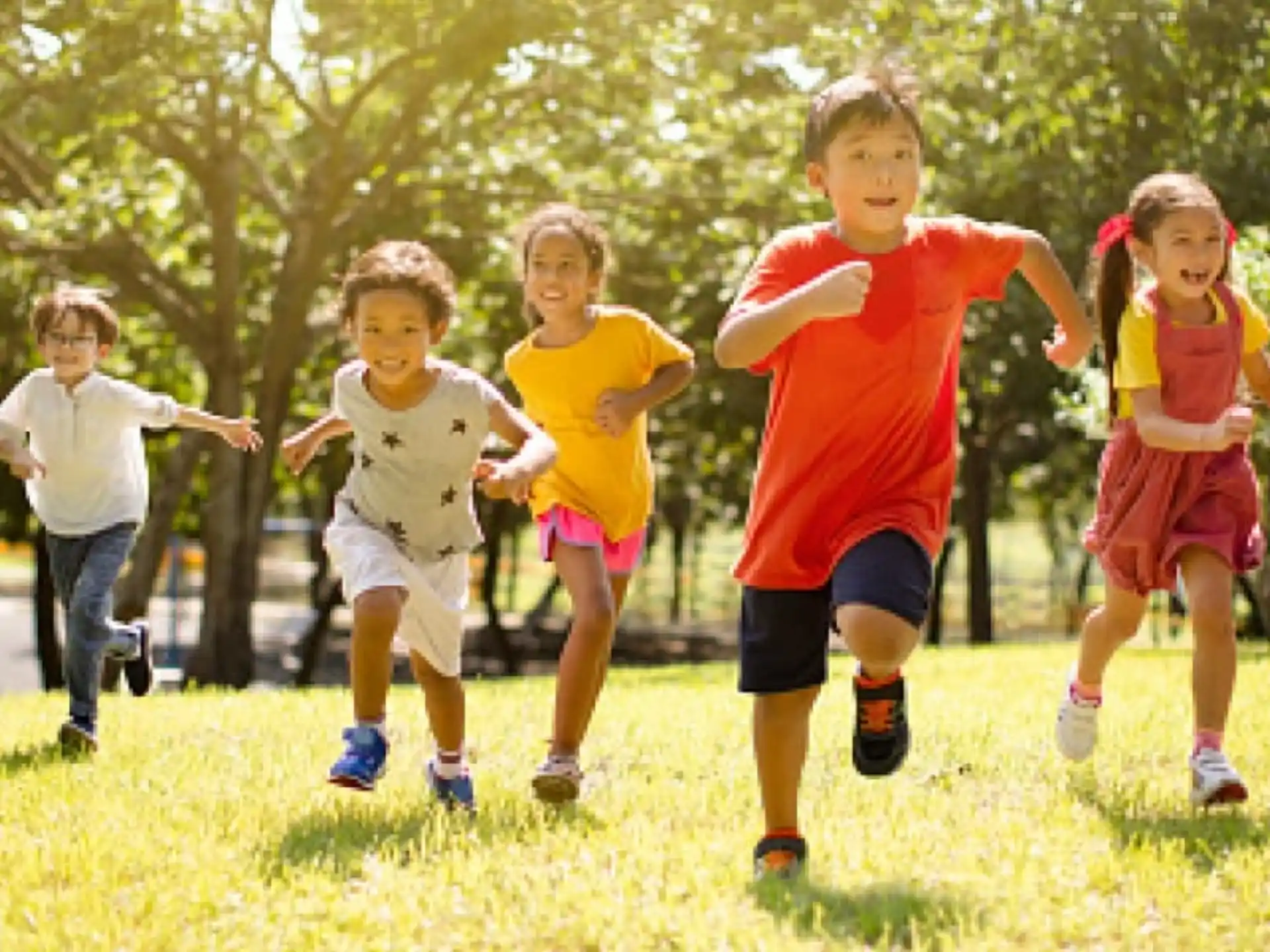 a group of children running on a field