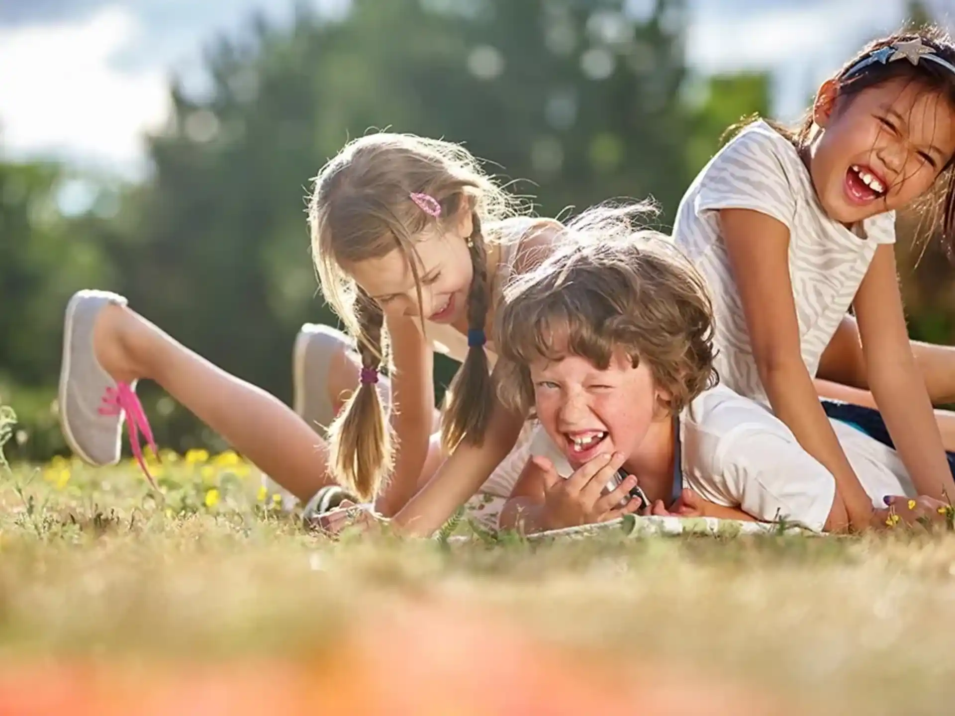 a group of girls lying in the grass
