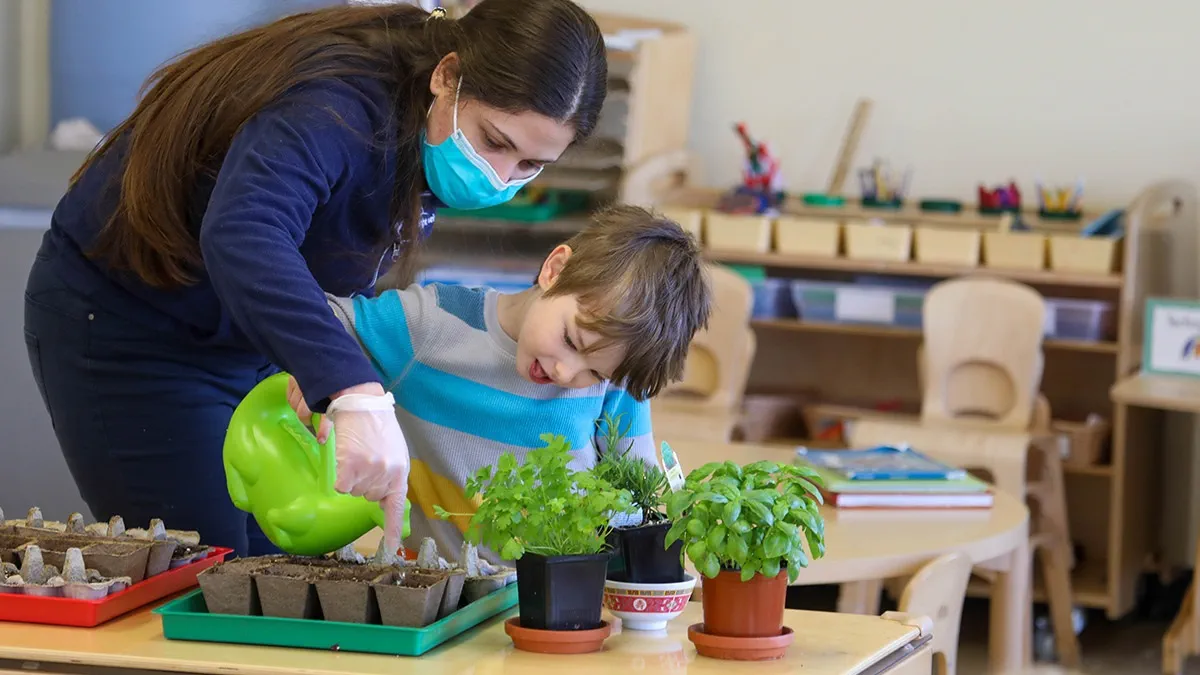a woman and a child planting plants