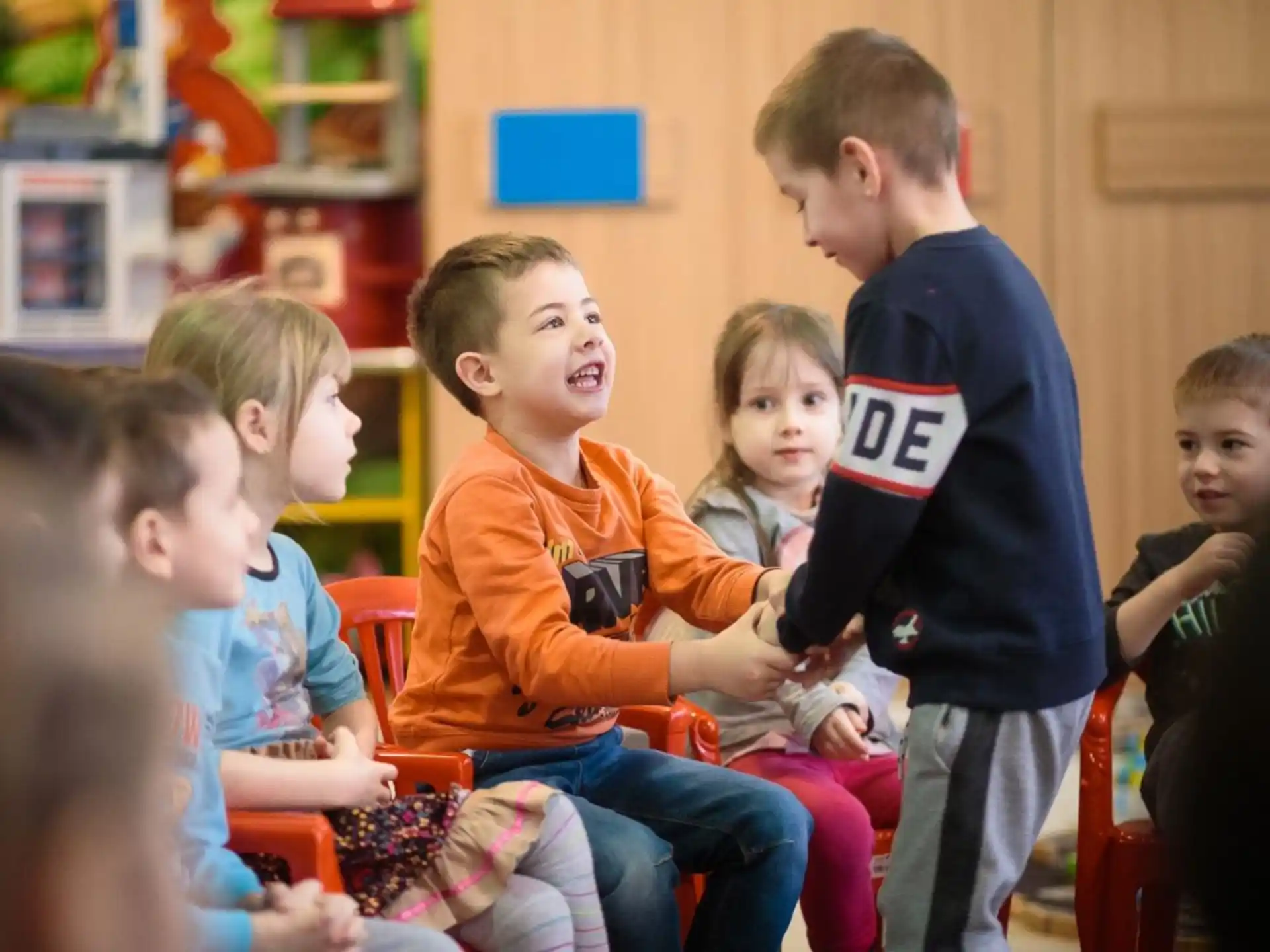 a group of children sitting in a room