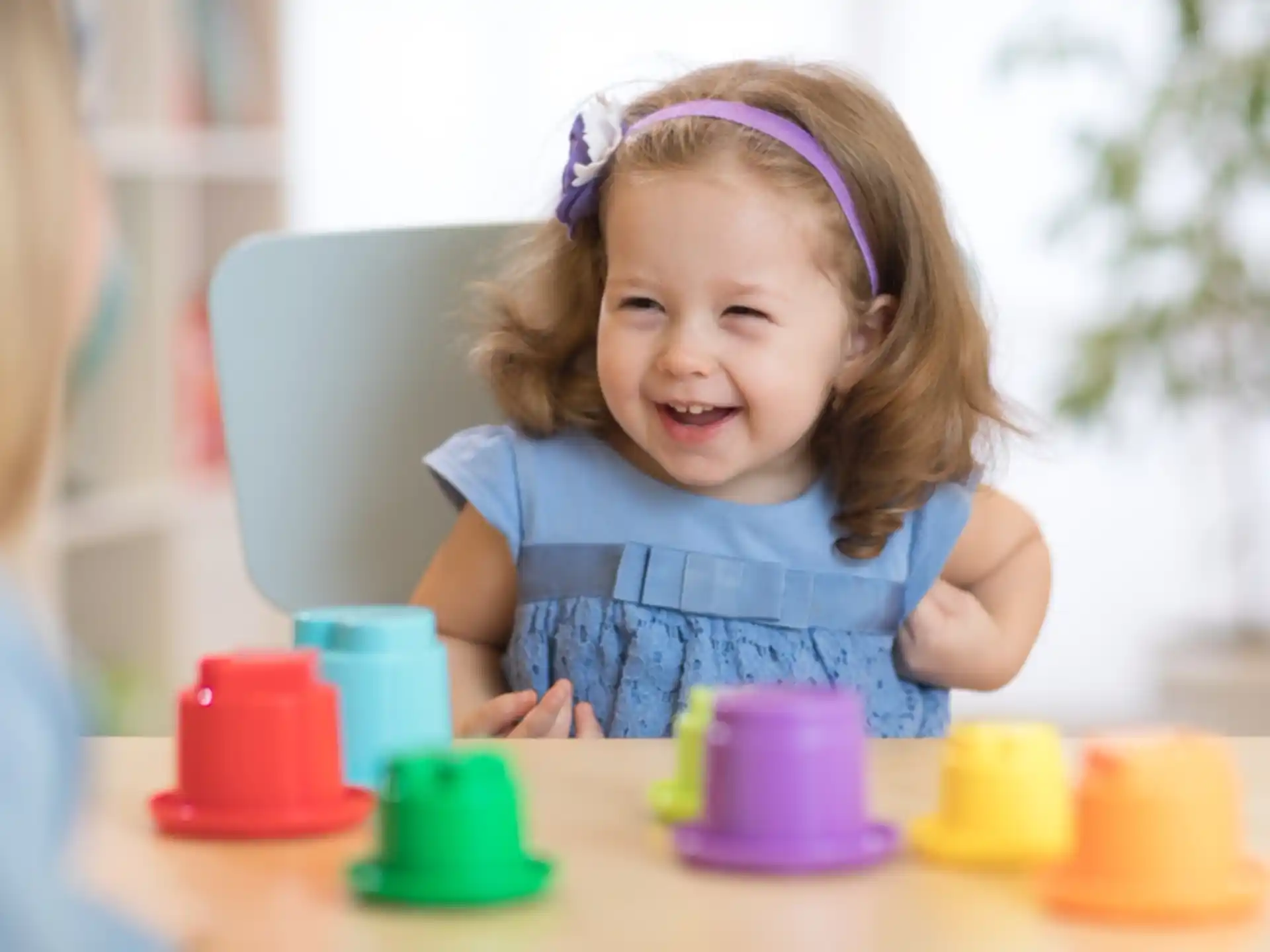 a little girl sitting at a table
