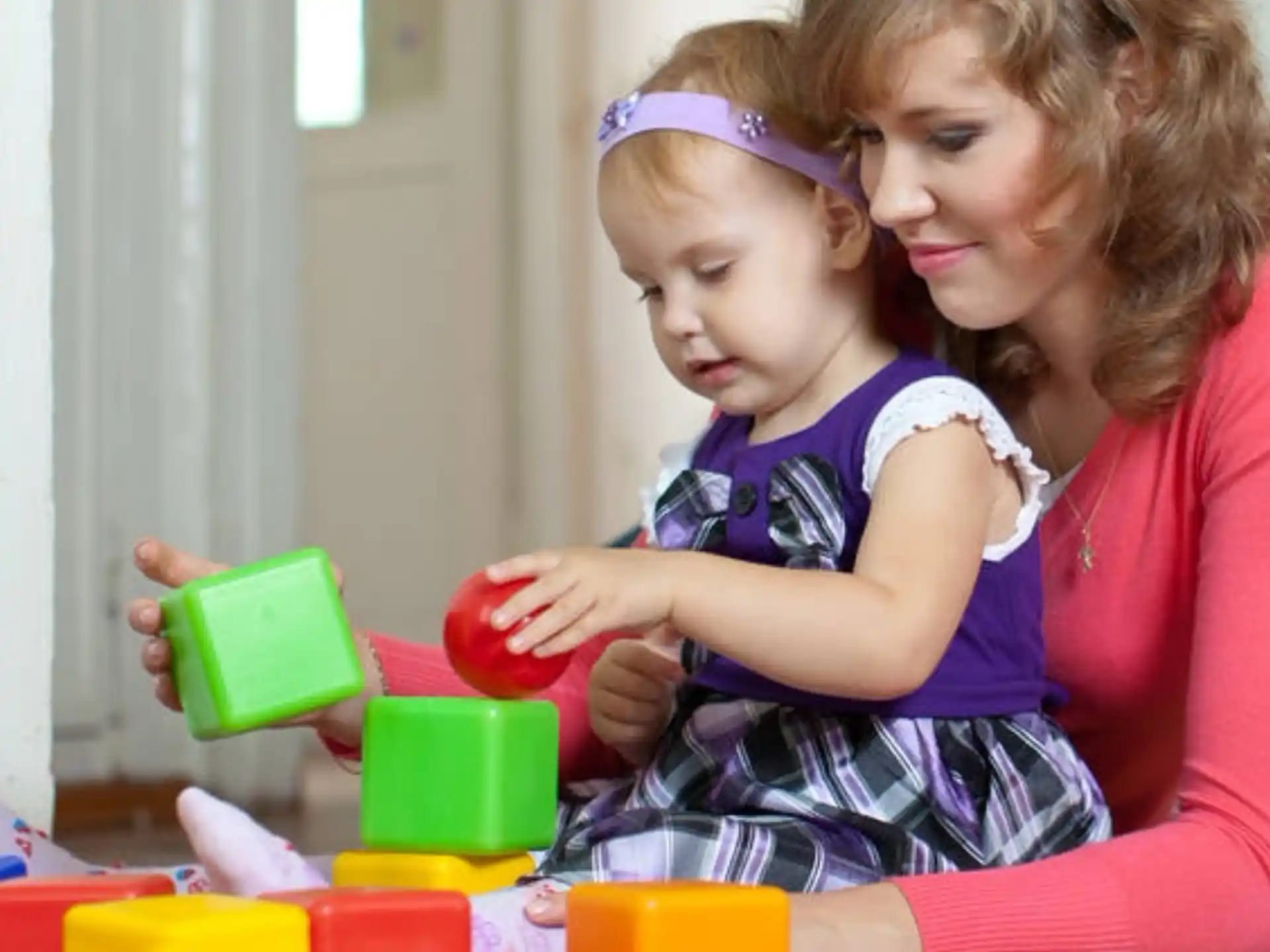 a person and a child playing with toys