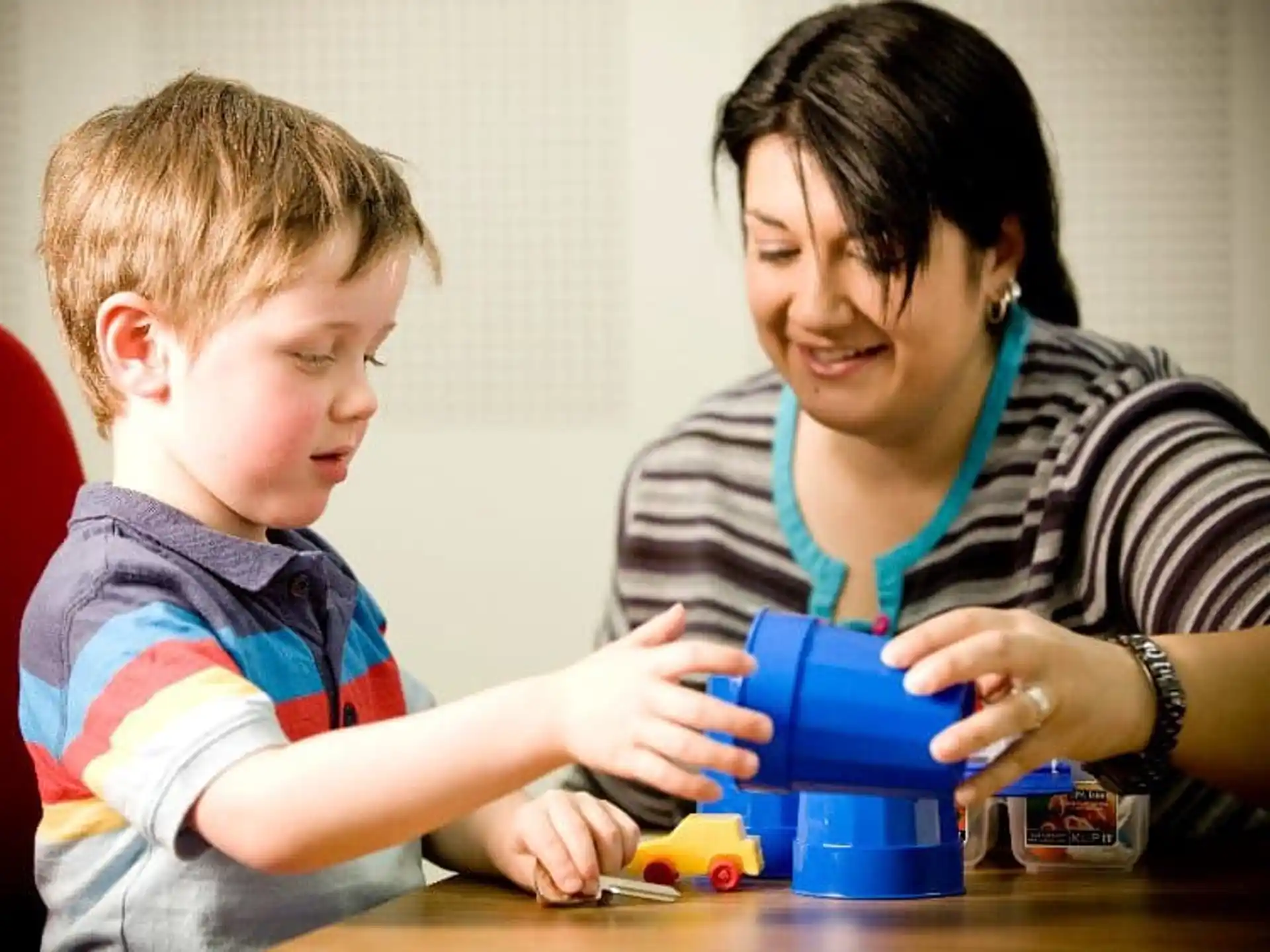 a person and a child playing with a toy