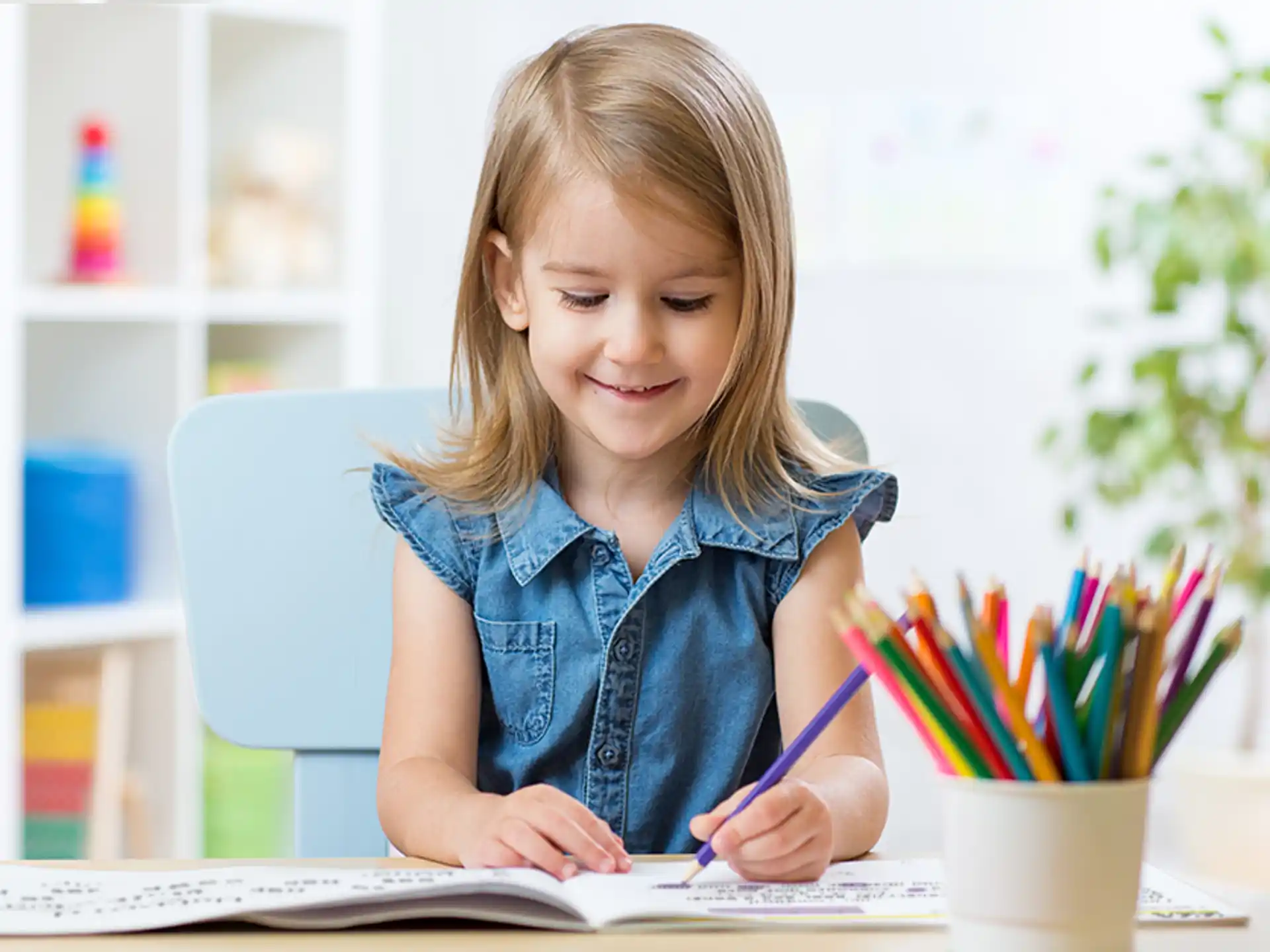 a young girl sitting at a desk
