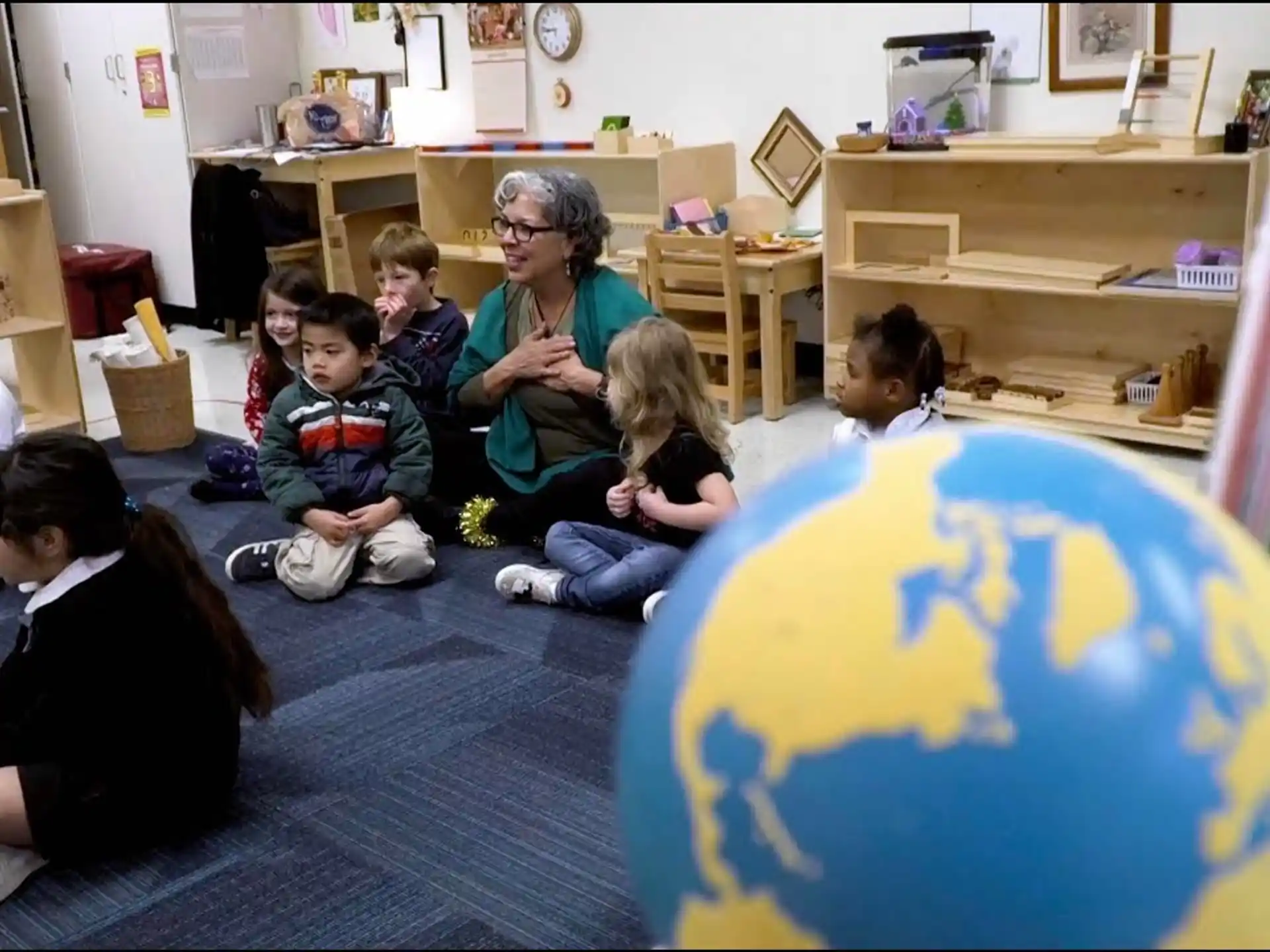 a person and several children sitting on the floor