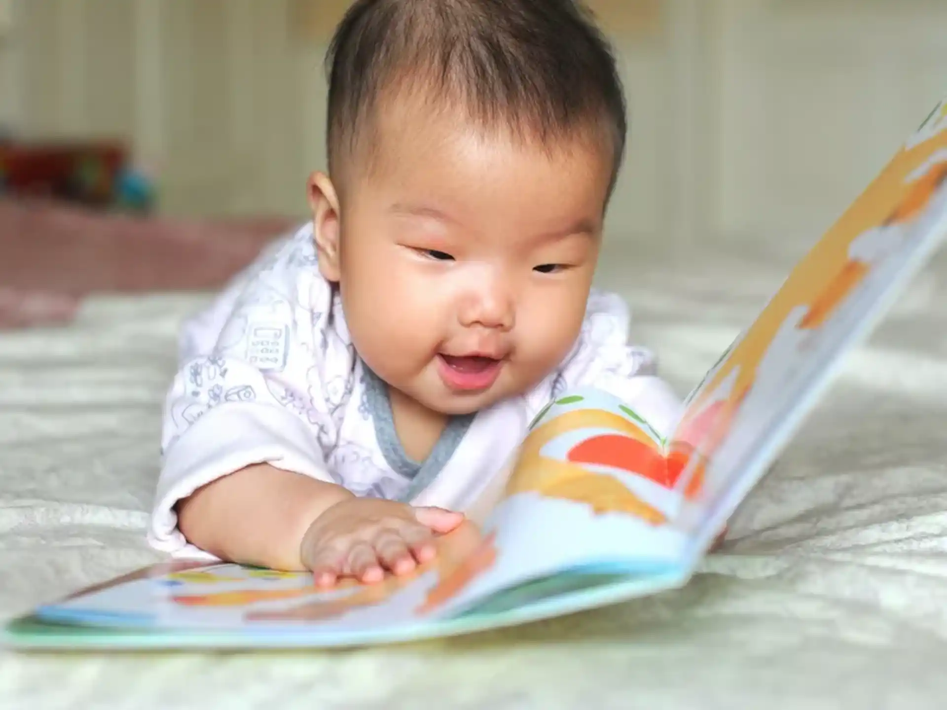 a baby looking at a book