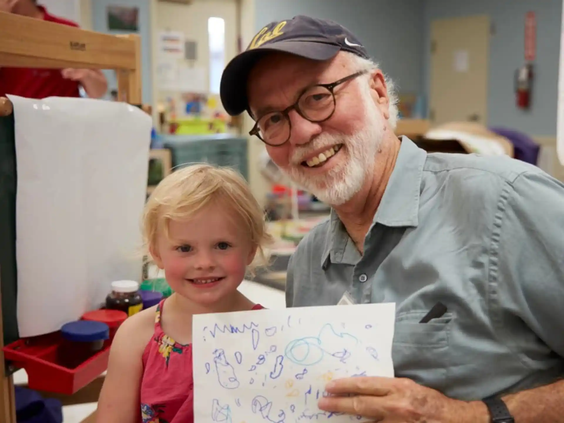 a man and a girl holding a piece of paper