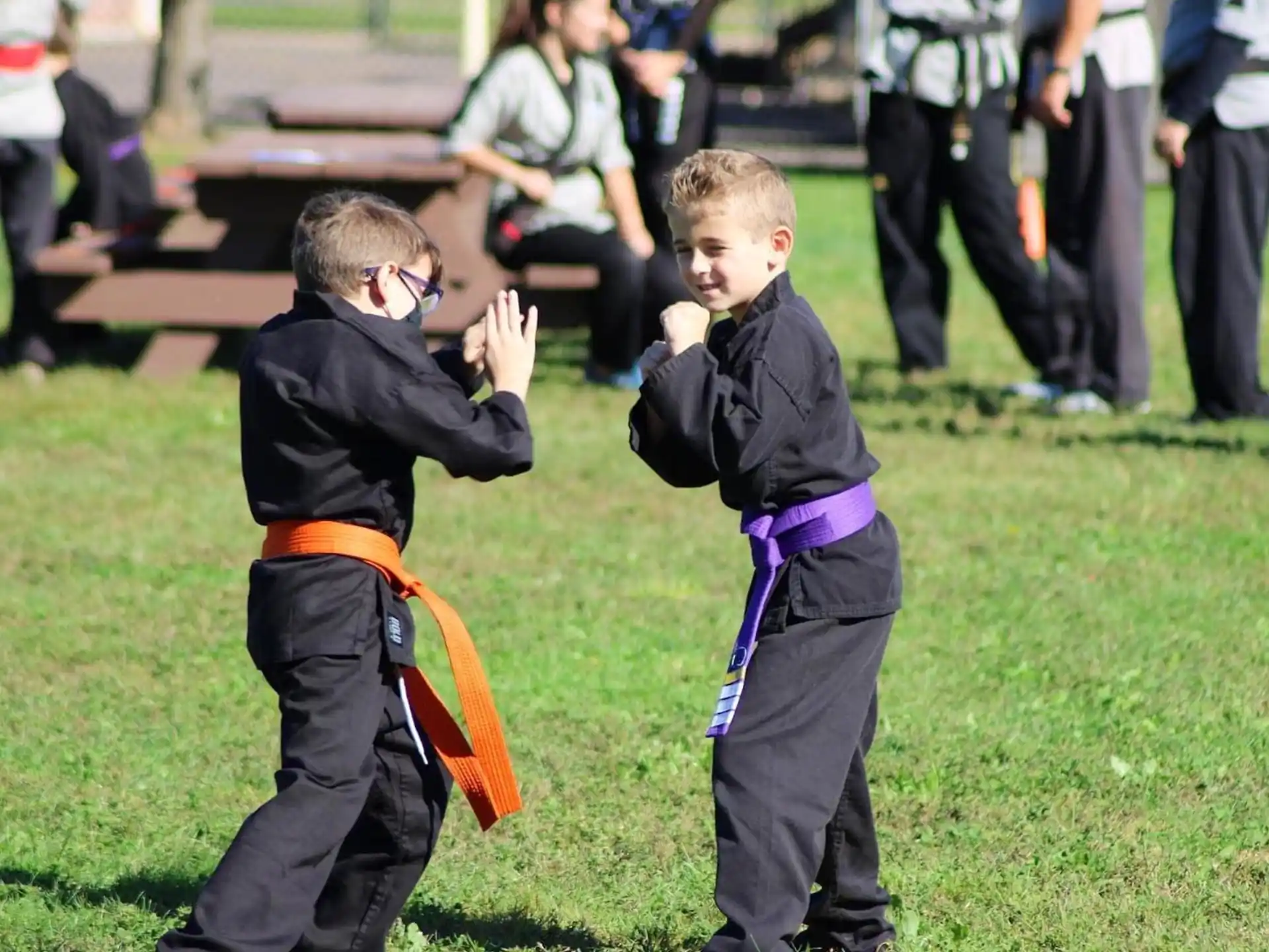 a couple of boys playing with a toy sword