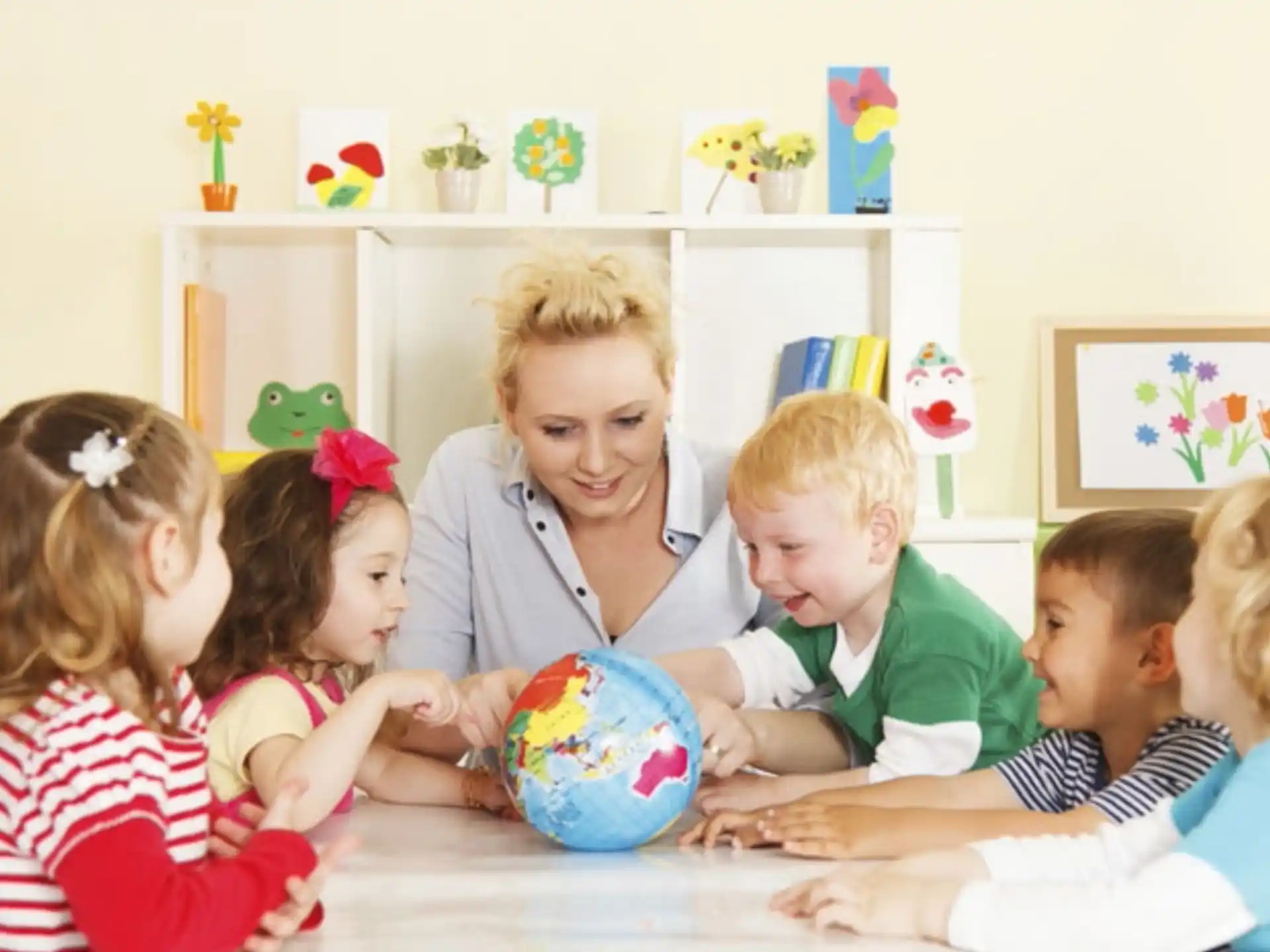 a group of children sitting around a table