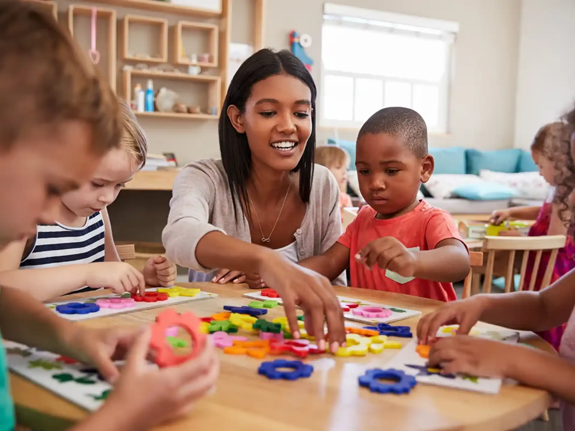a person and children playing a board game