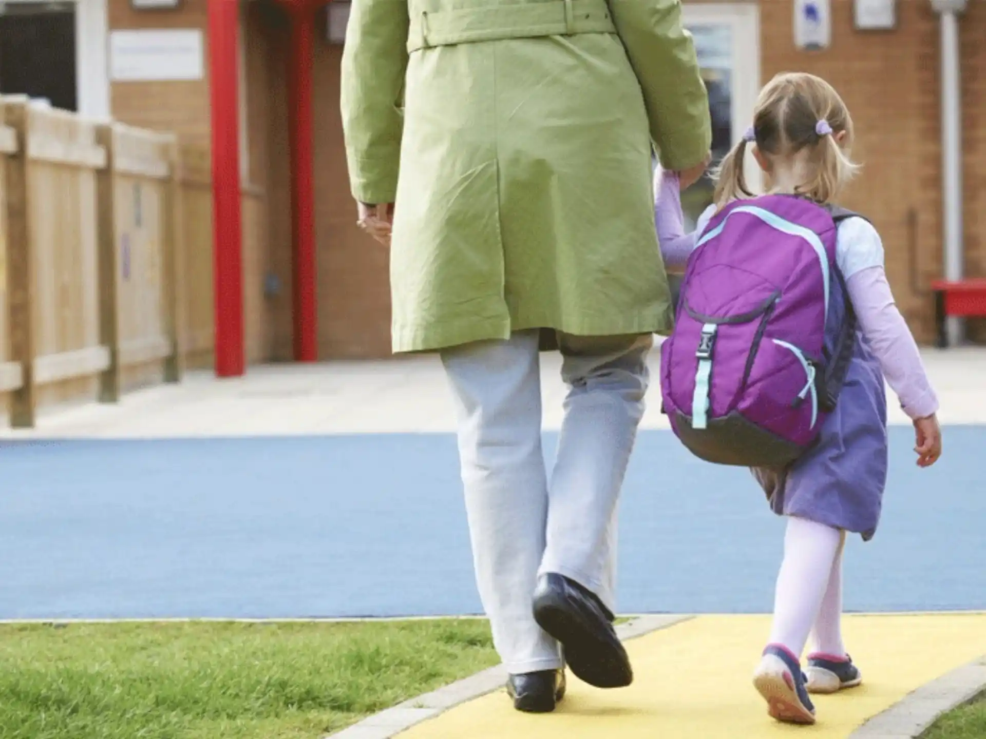 a woman walking with a girl