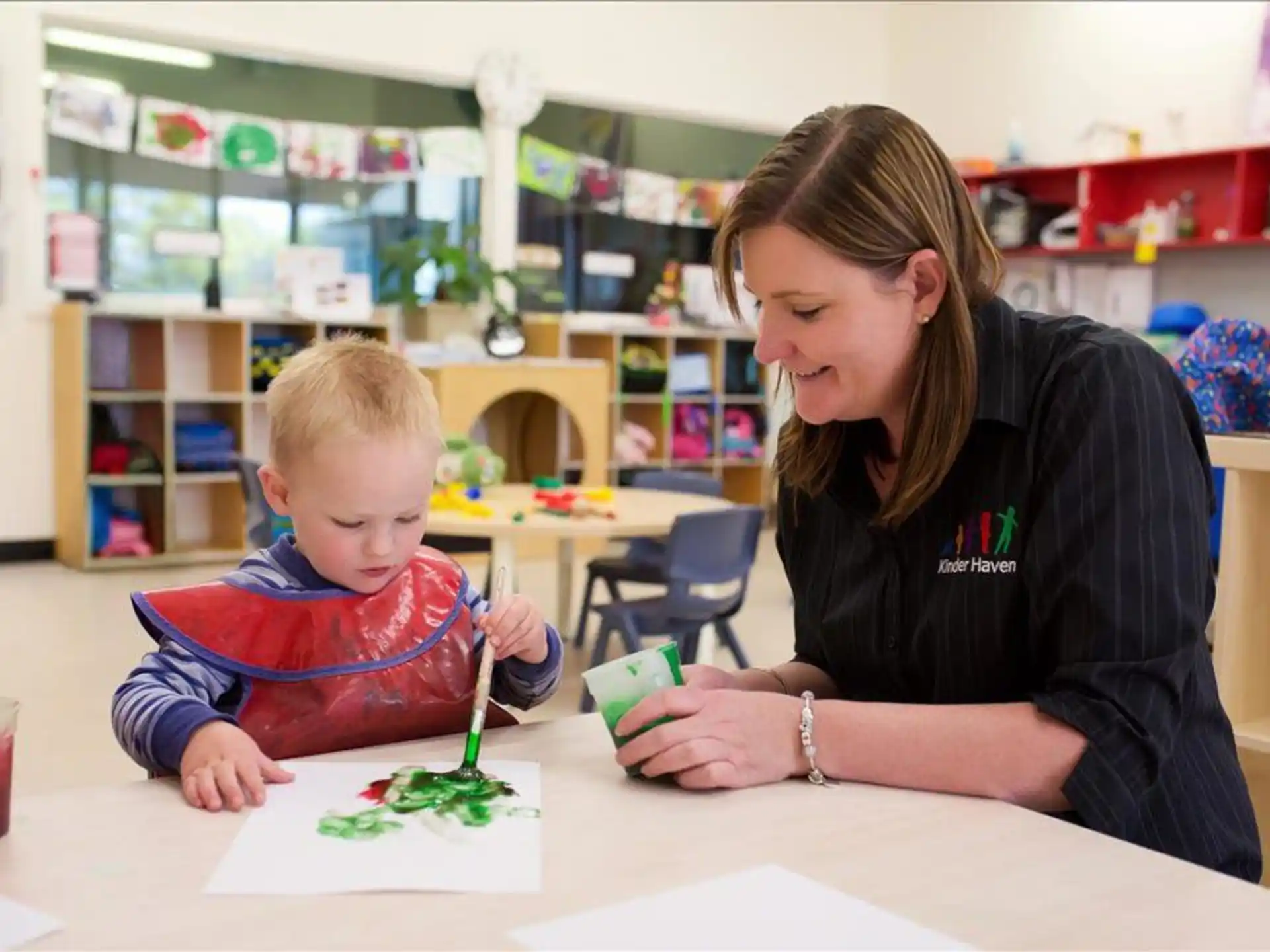 a woman and a child painting