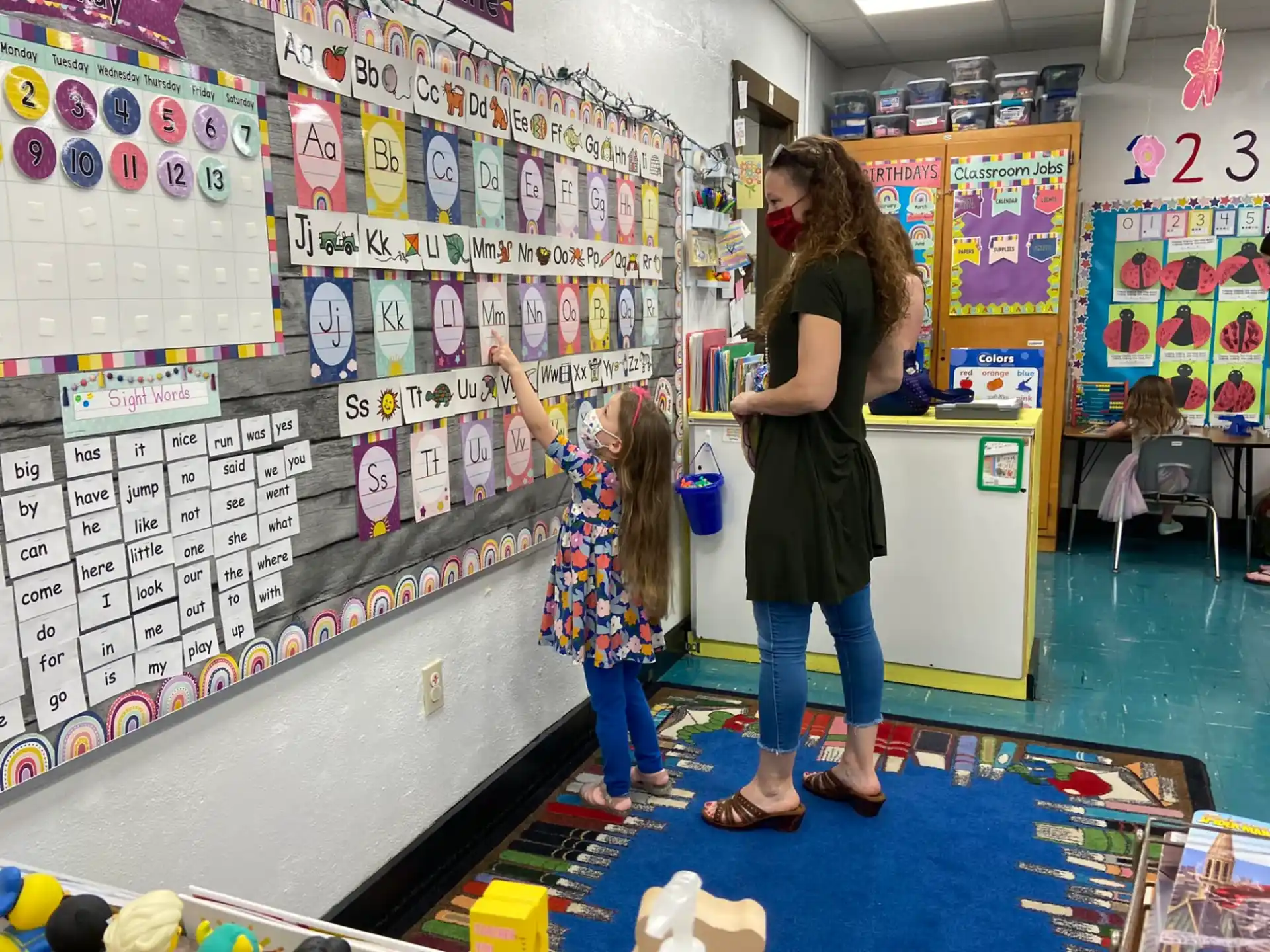 a person and a girl in a classroom