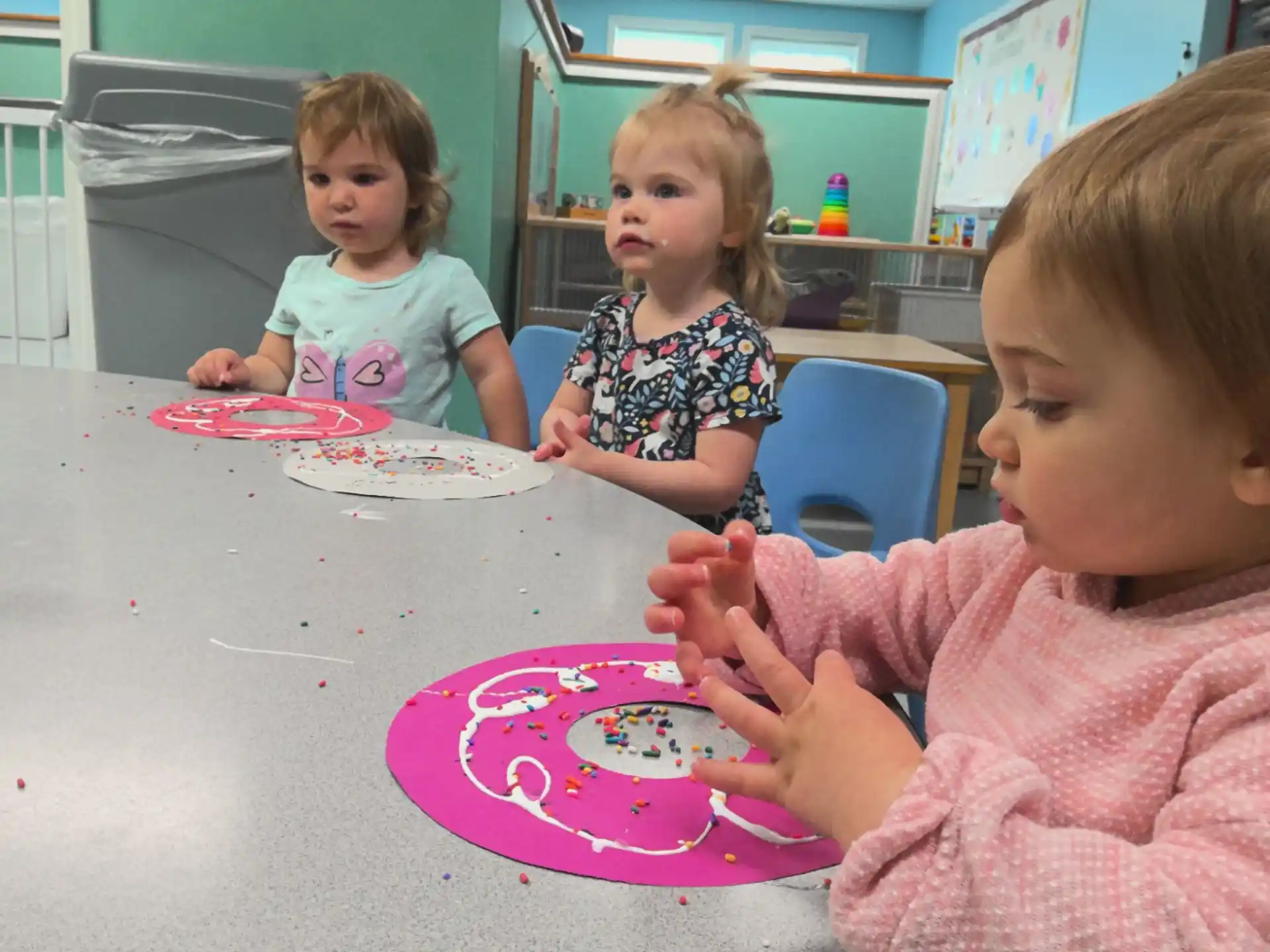 a group of children sitting at a table